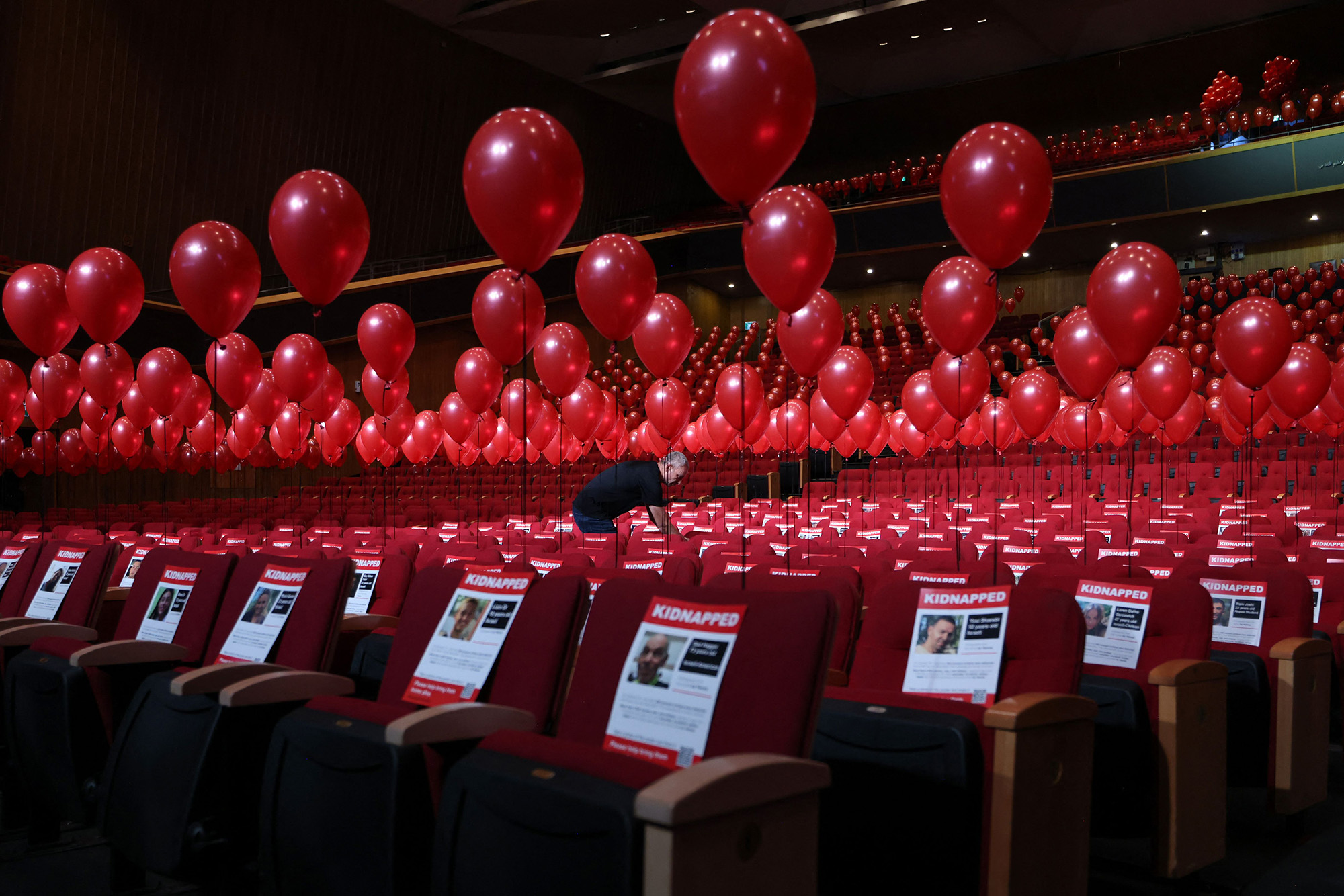 An installation consisting of balloons and pictures of Israeli hostages abducted by Hamas militants attached to auditorium seats at the Jerusalem Convention Centre on November 2.