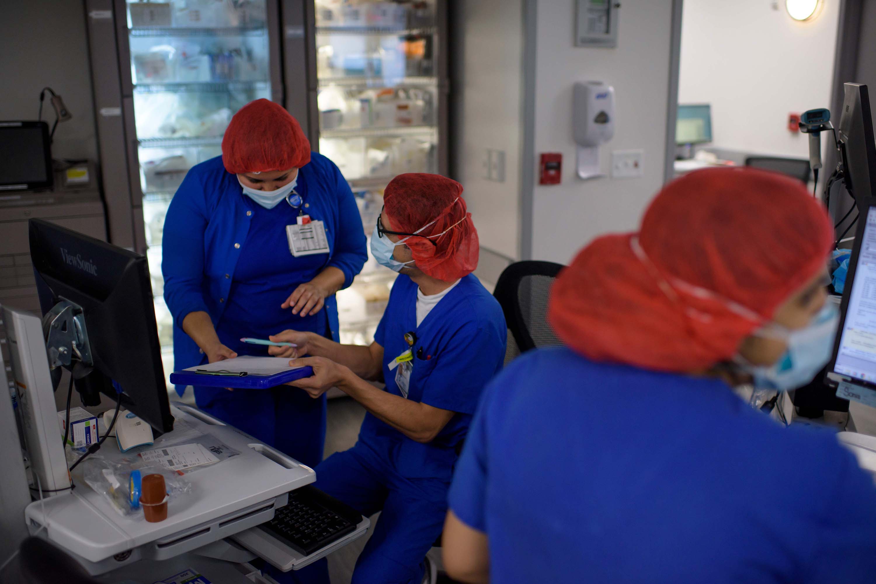 Healthcare professionals work in the ICU at Oakbend Medical Center in Richmond, Texas, on Wednesday, July 15.