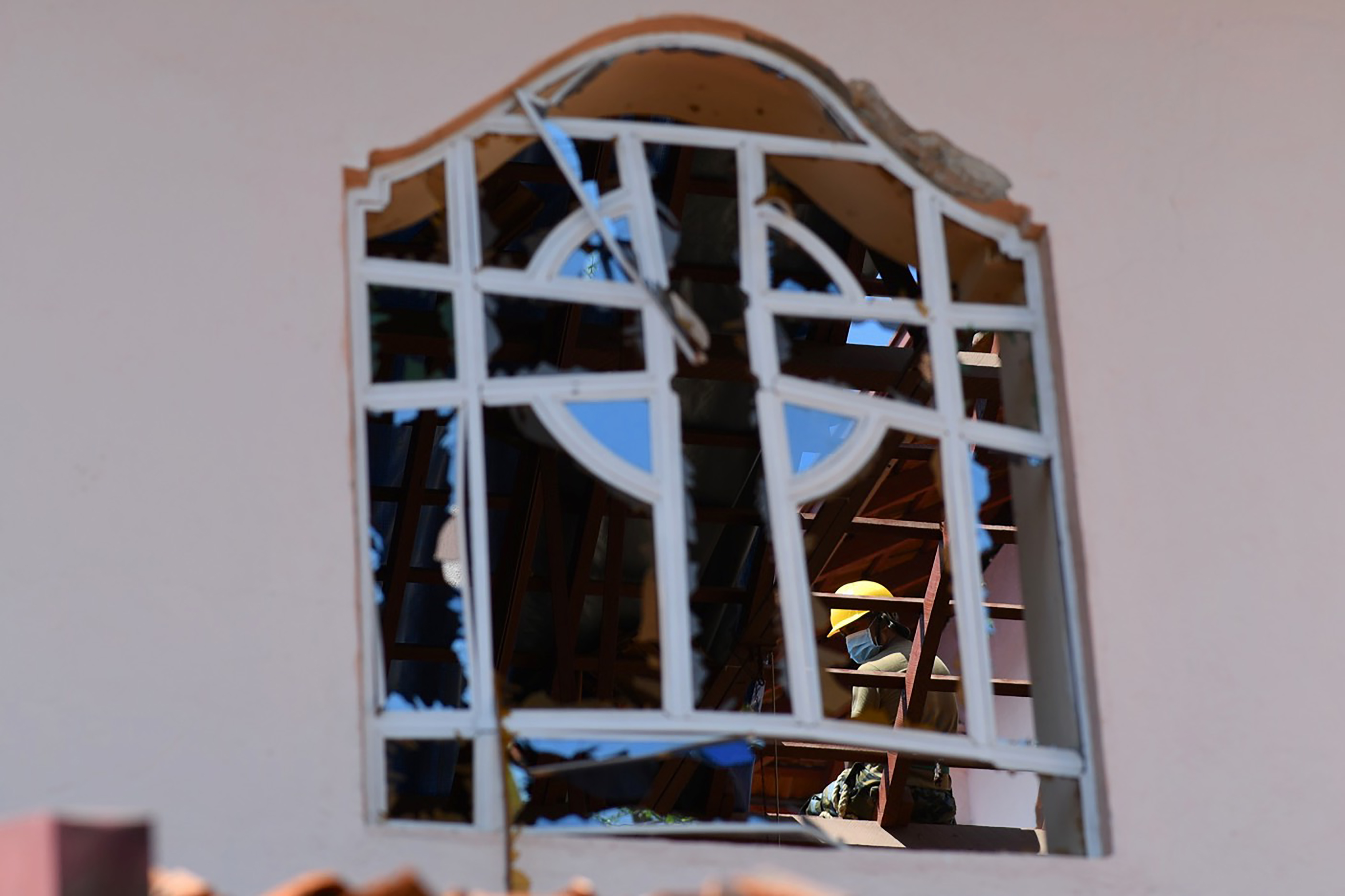 A worker clears debris from the roof of St. Sebastian's Church in Negombo on April 22, 2019, a day after the church was hit in a series of bomb blasts targeting churches and luxury hotels in Sri Lanka.