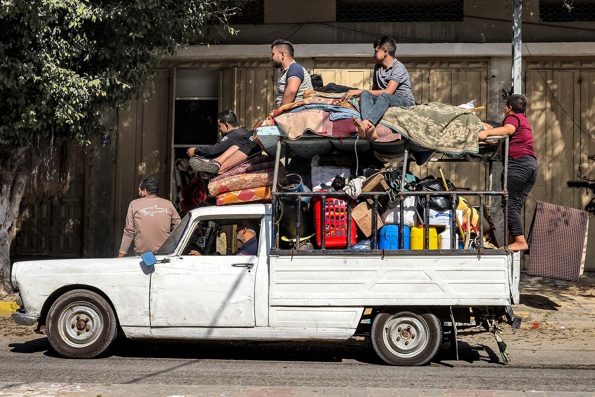 People ride with their belongings after evacuating their home in Rafah, Gaza, on November 1.