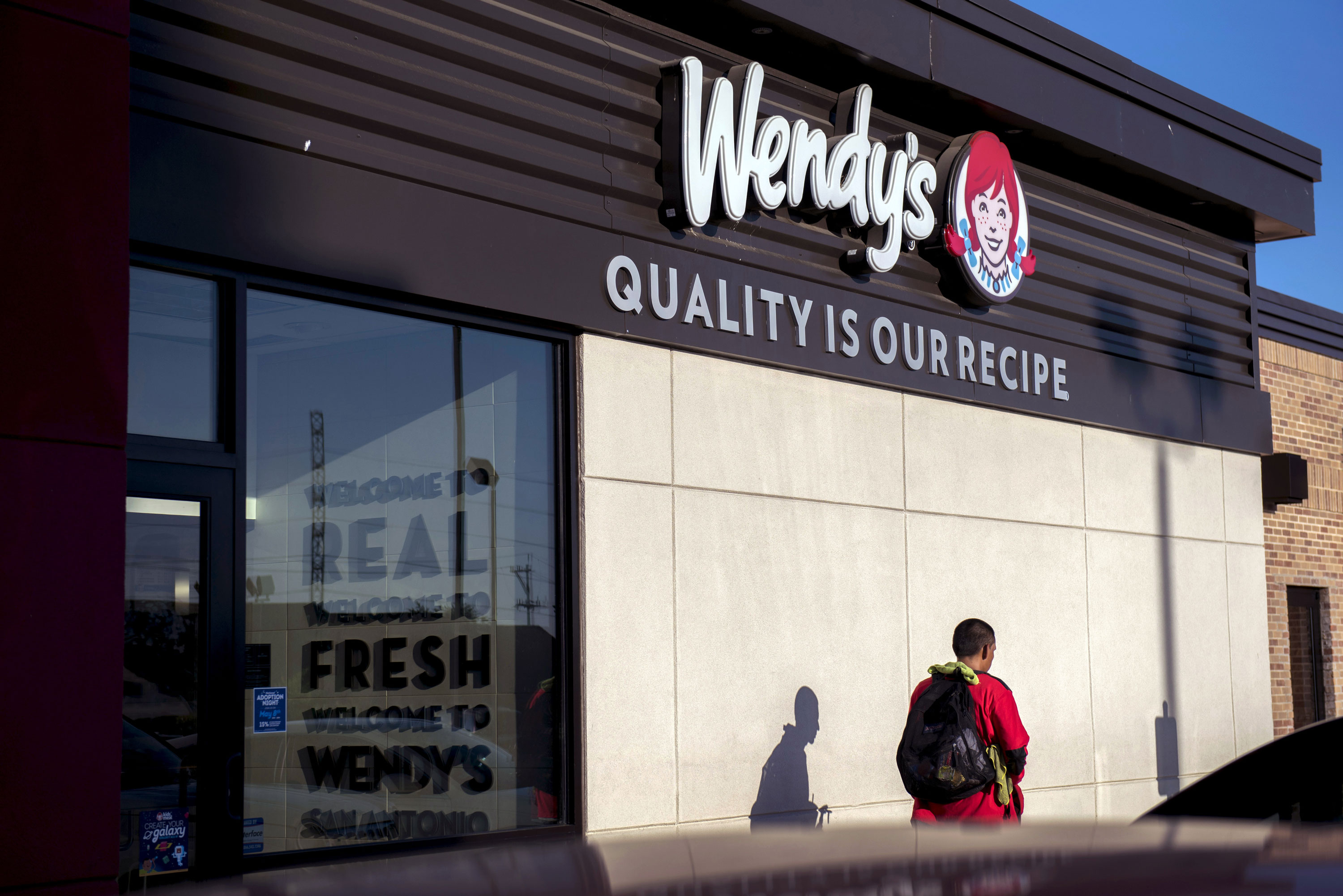 A customer exits a Wendy's Co. fast food restaurant in San Antonio, Texas, on May 6, 2018. 