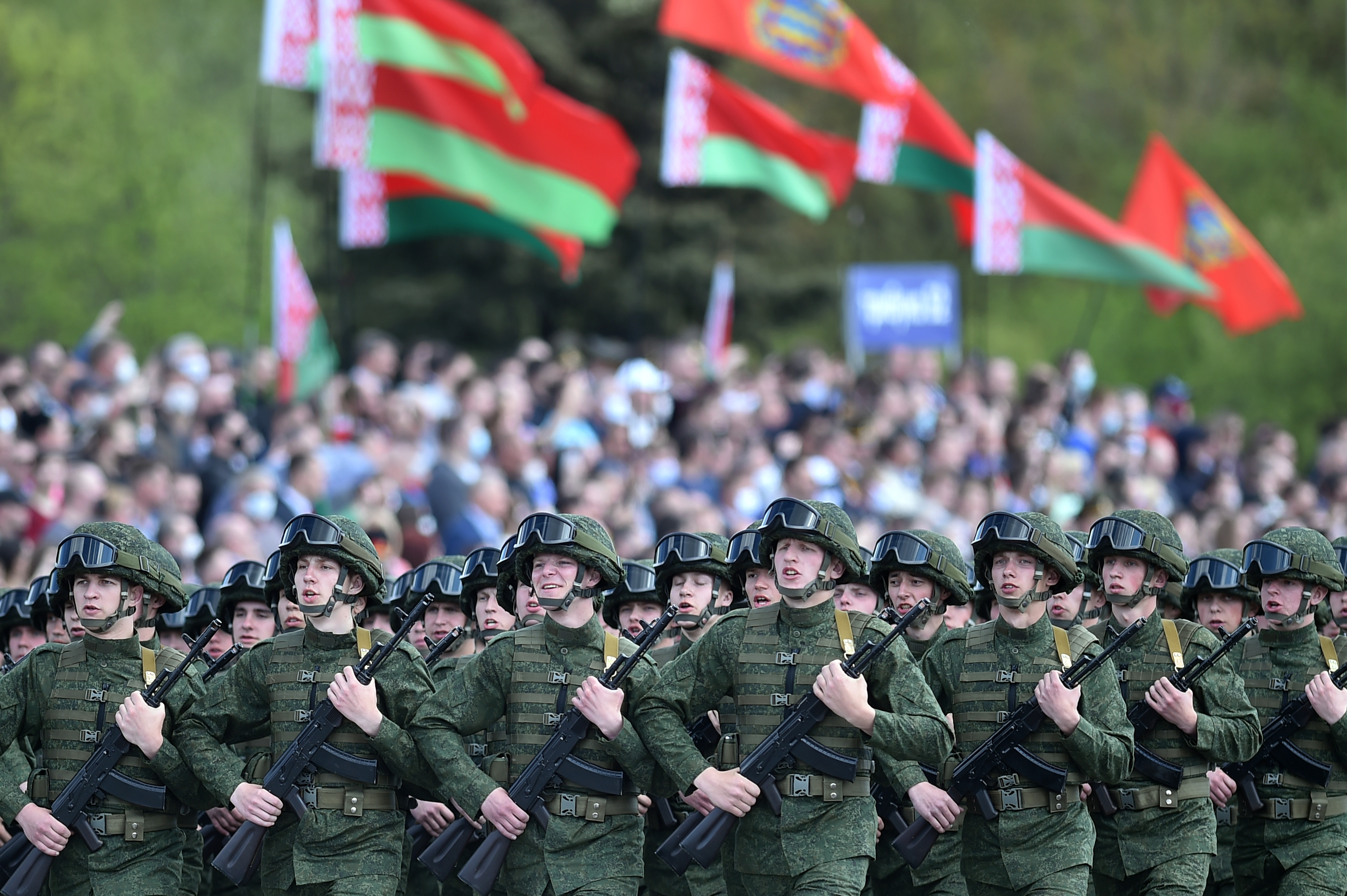 Belarusian servicemen march for the 75th anniversary of the end of World War II, as a crowd watches on with no social distancing measures in place.