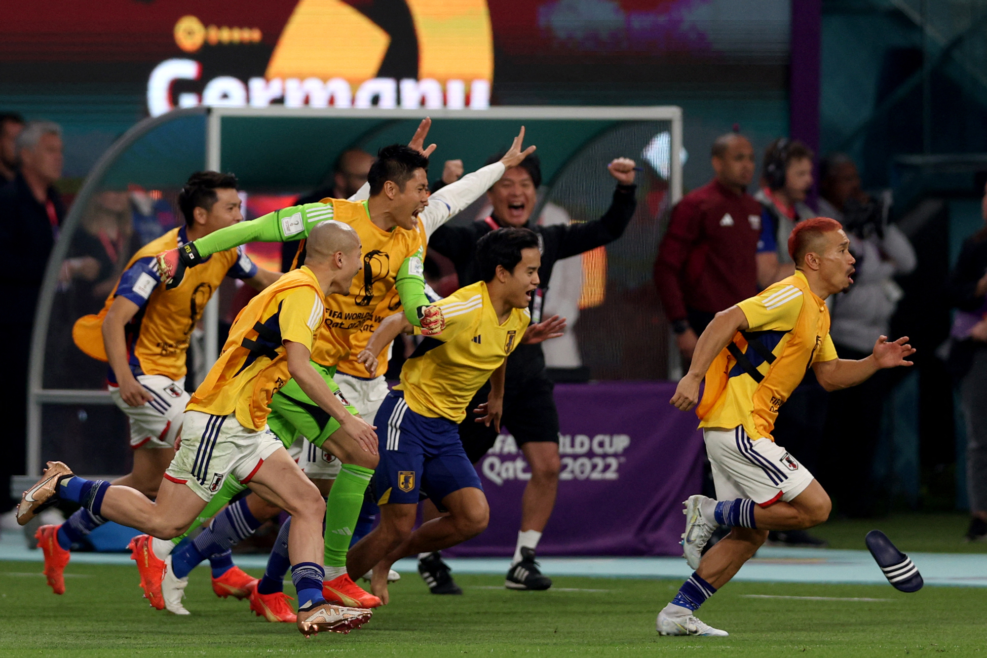 Japan's players celebrate their win against Germany at the Khalifa International Stadium in Doha, Qatar on Wednesday.