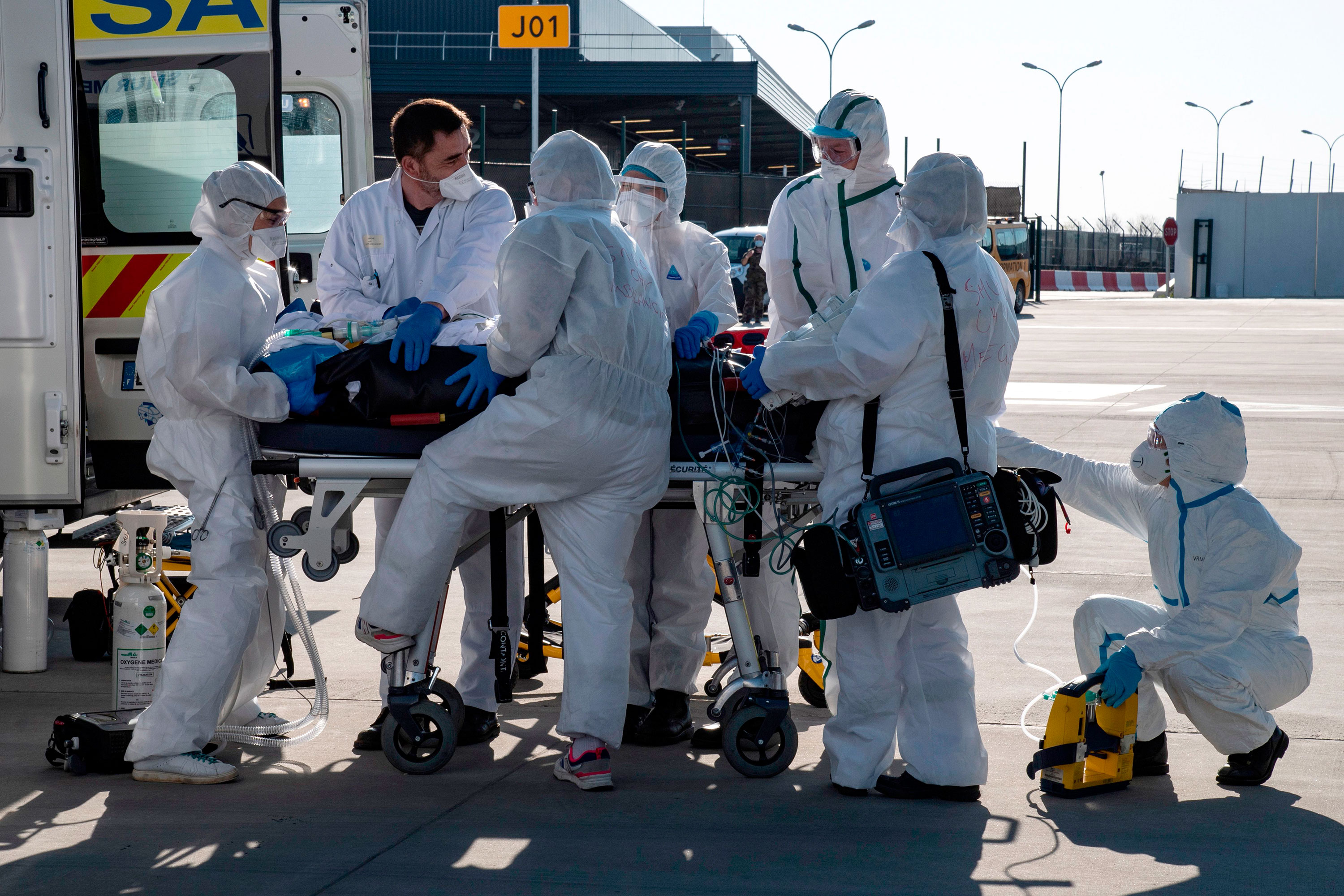 Medical staff load a coronavirus patient into a plane for transport to a hospital outside of the Paris, on April 4.