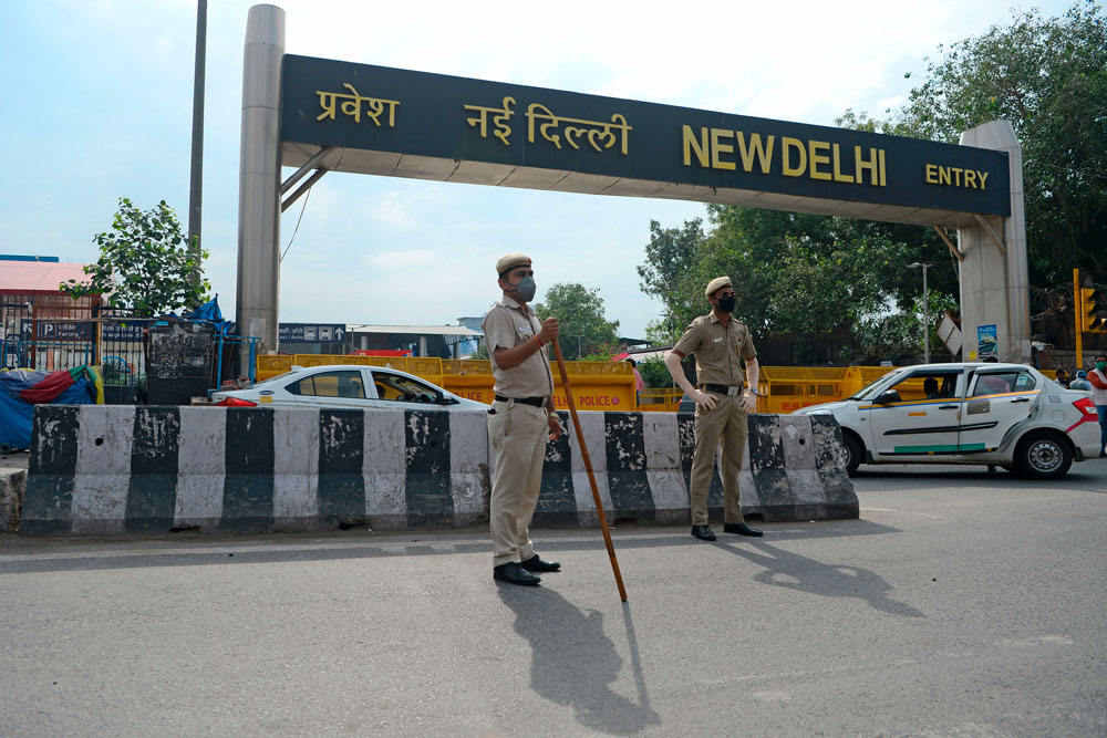 Police personnel stand guard outside the entrance of a railway station in New Delhi on May 12. 