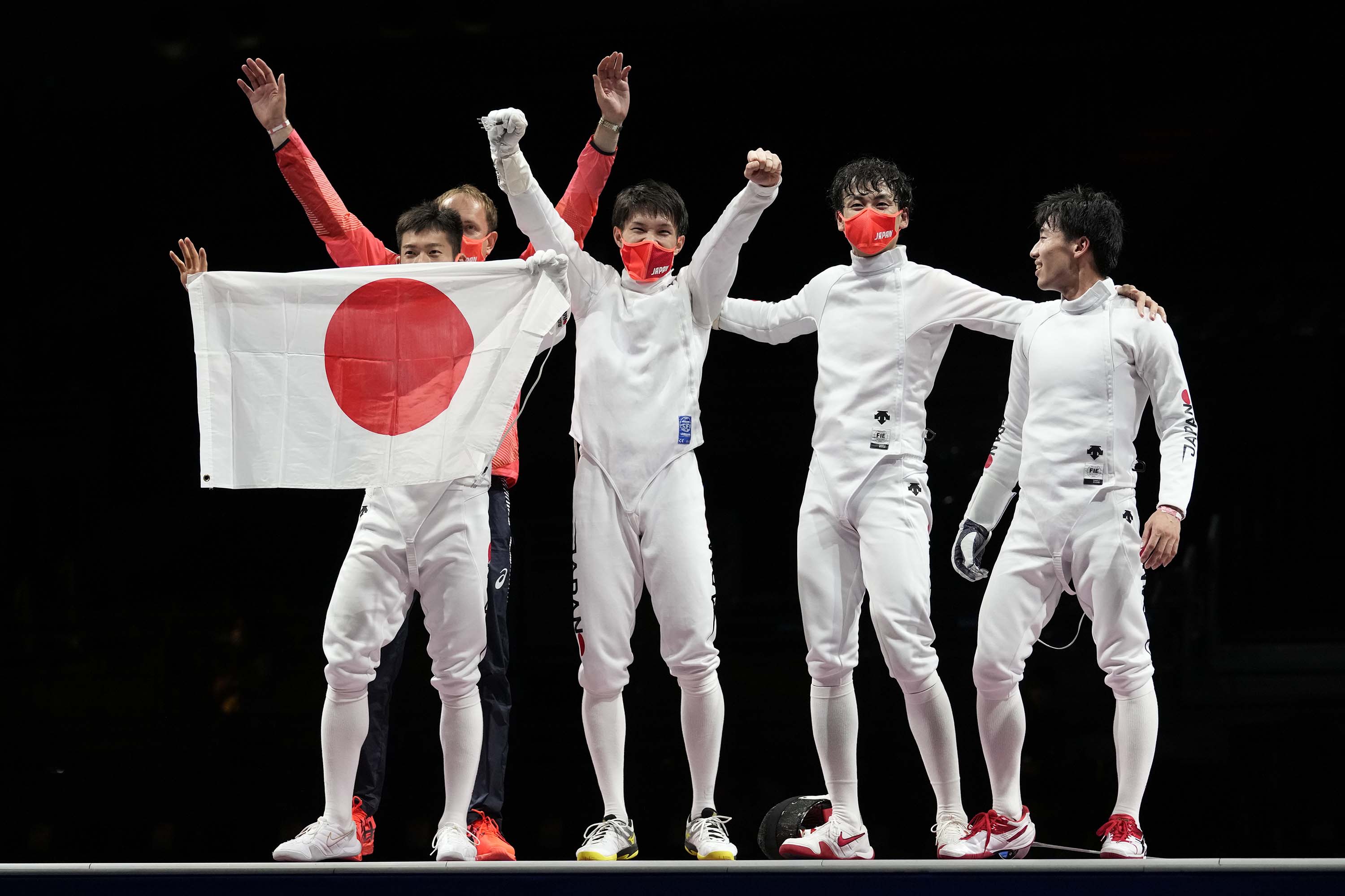Team Japan celebrate after winning the men's team épée final in Chiba, Japan, on Friday. 