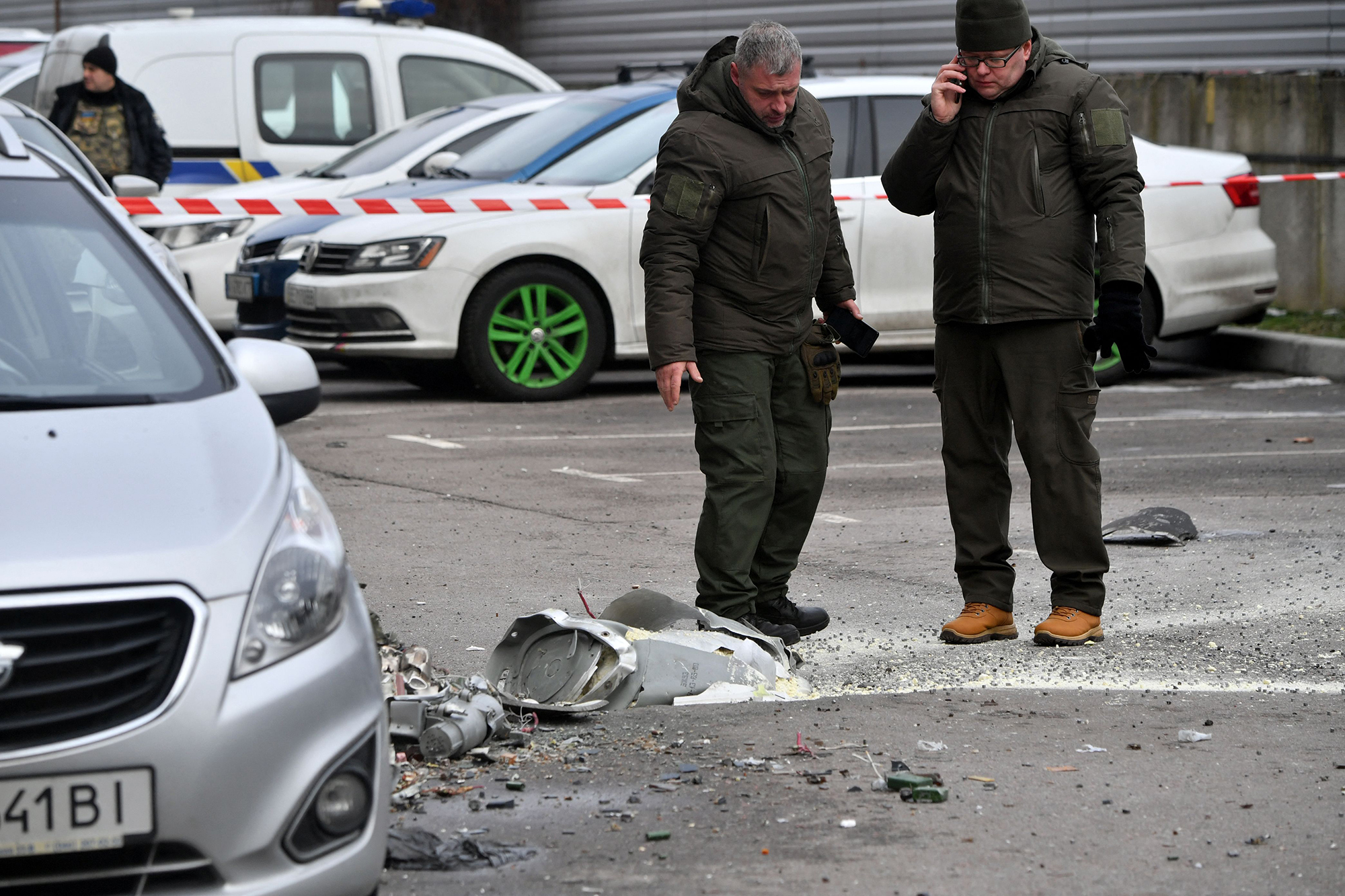 Police experts examine the remains of a downed missile in Kyiv, Ukraine, on December 29.