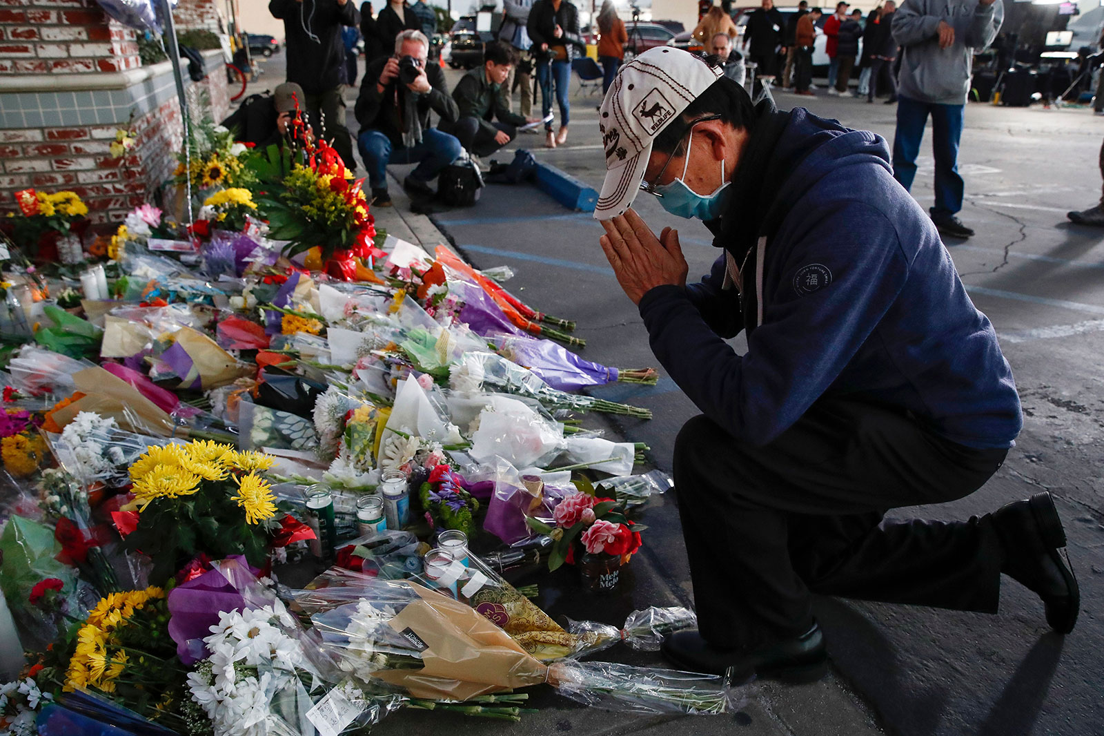 A person visits a makeshift memorial outside the dance studio in Monterey Park on Monday. 