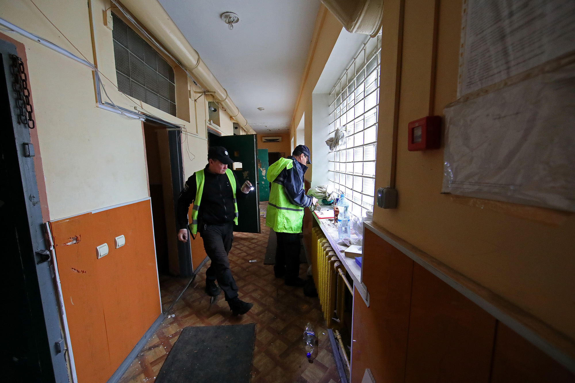 Forensic experts collect the pieces of evidence at the District Police Department used by Russian forces for torture in Balakliia, Ukraine in the Kharkiv Region on September 13. 