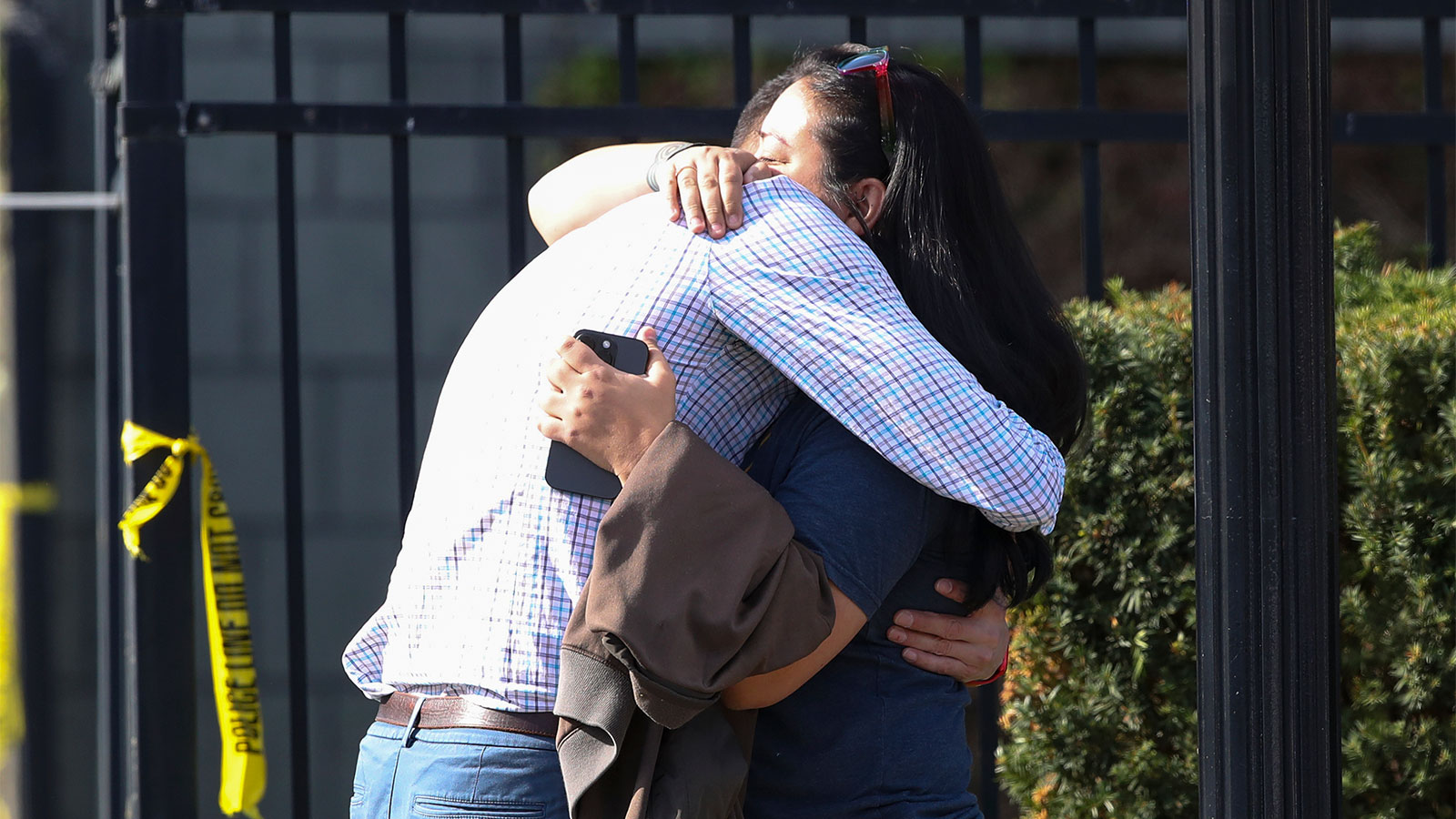 Two people embrace outside of a building where a shooting took place in Louisville, Kentucky, on Monday, April 10. 