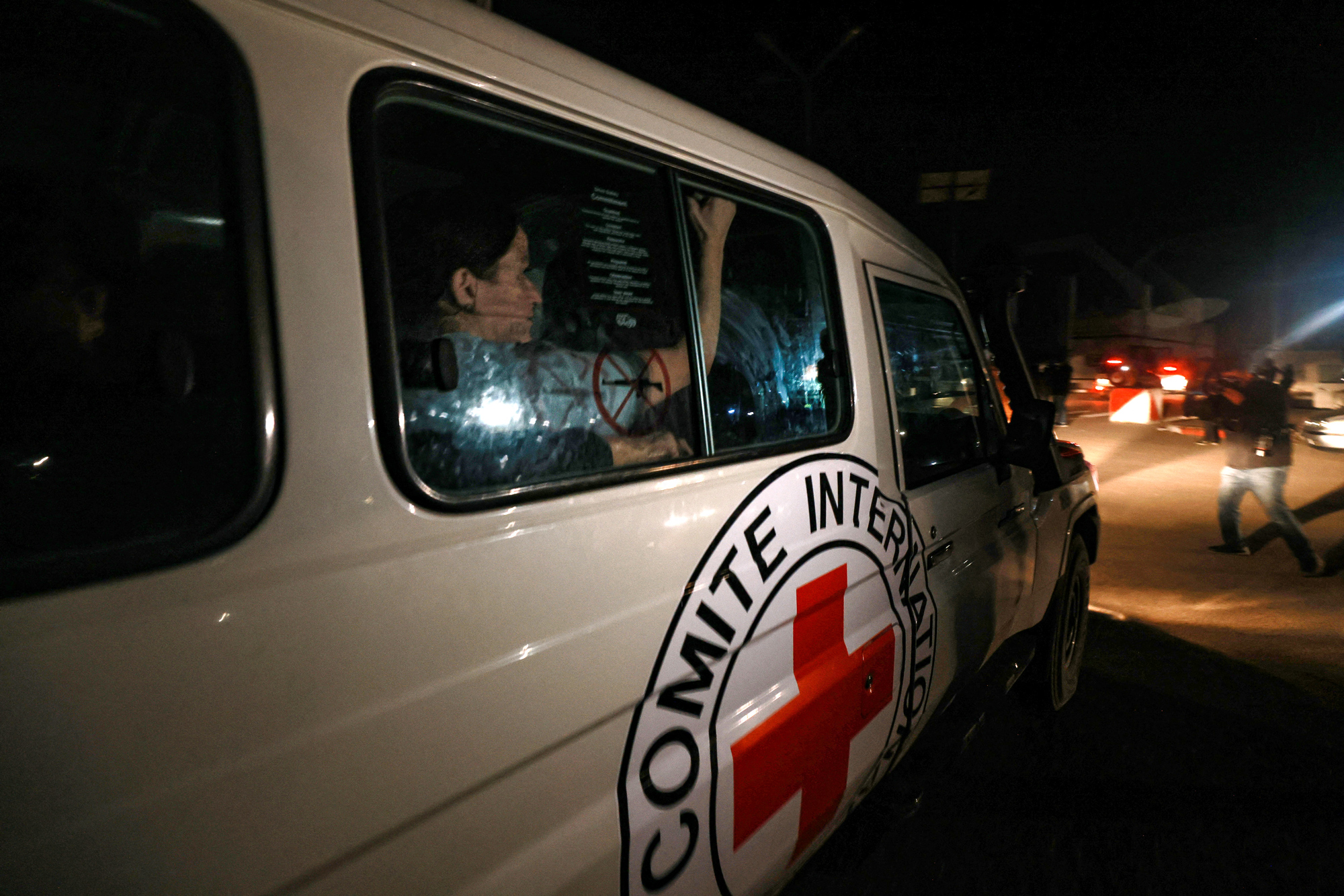 A Red Cross vehicle carrying newly released hostages drives towards the Rafah border point with Egypt, in southern Gaza, on November 28.