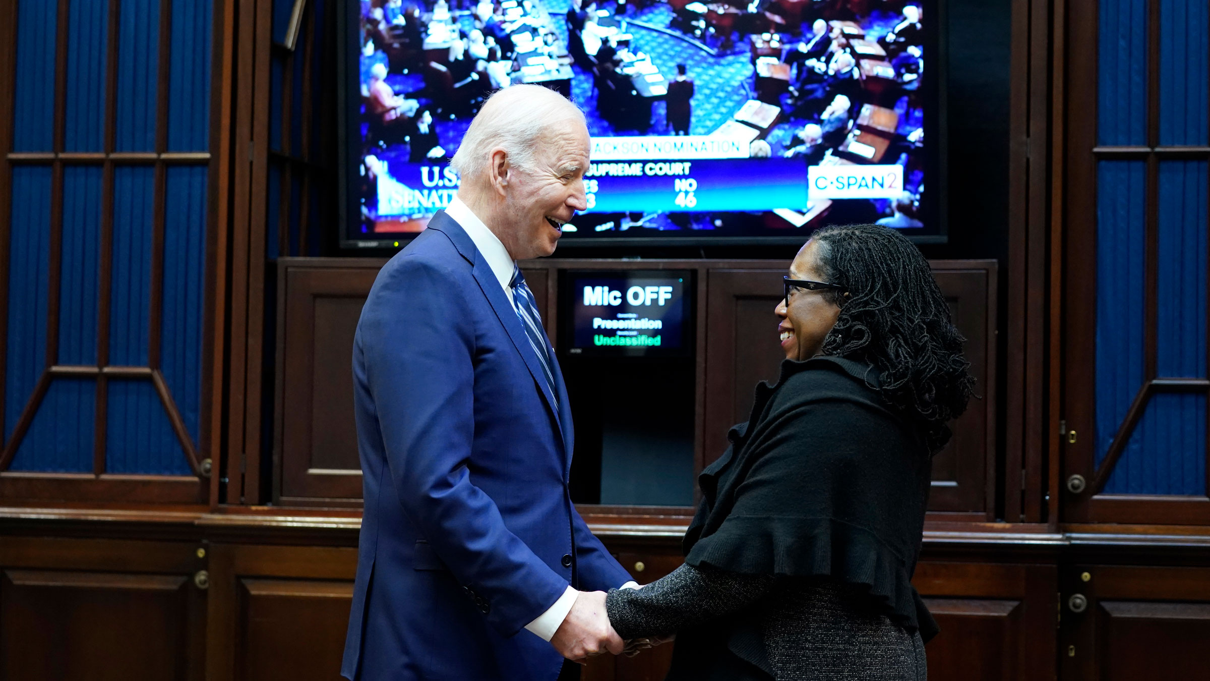 President Joe Biden talks with Ketanji Brown Jackson as they watch the Senate vote on her confirmation in April.