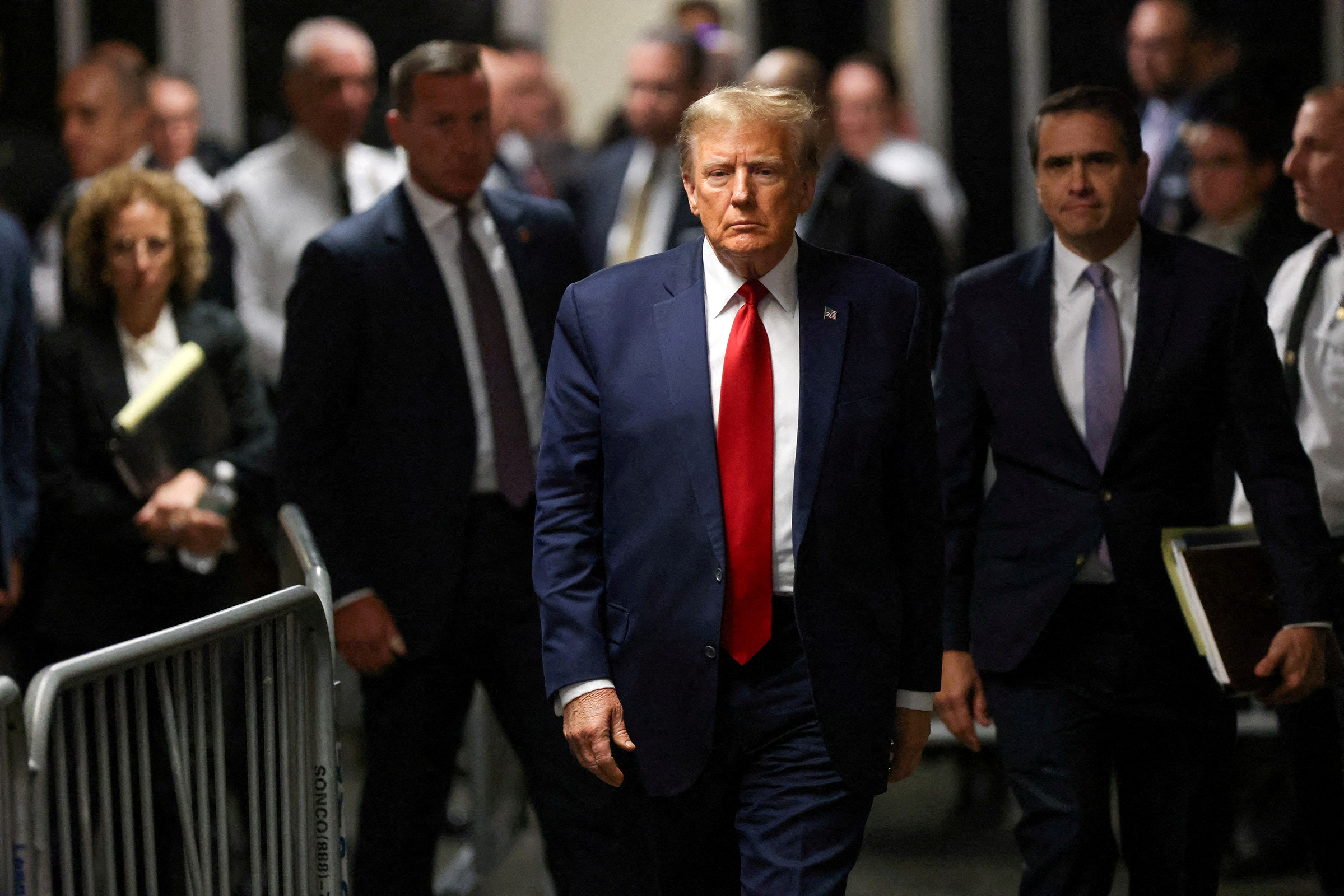 Former President Donald Trump walks outside the courtroom on the day of a court hearing on charges of falsifying business records to cover up a hush money payment to a porn star before the 2016 election, in New York State Supreme Court in February.