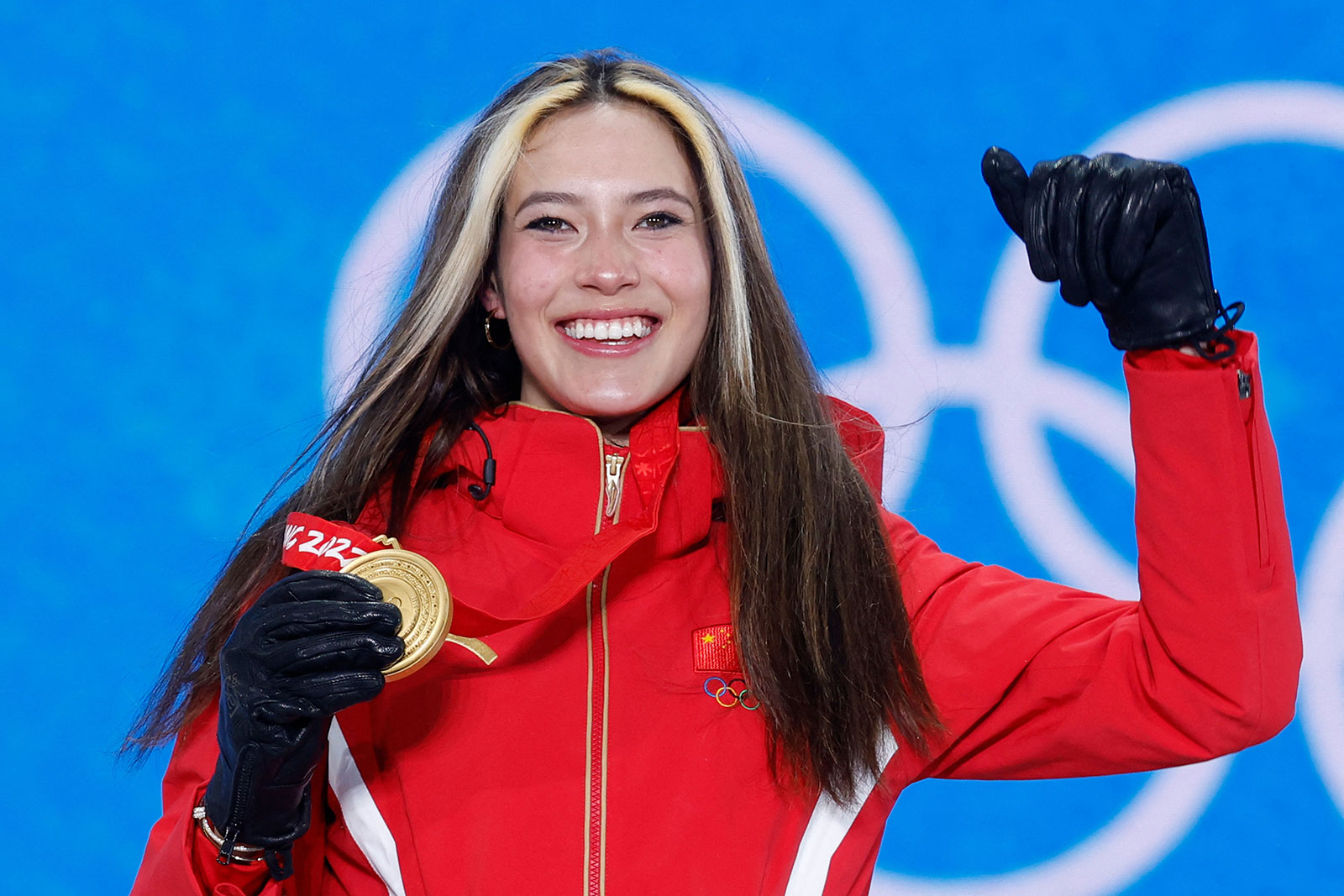 Eileen Gu celebrates during the medal ceremony for the women's freeski halfpipe event on February 18.