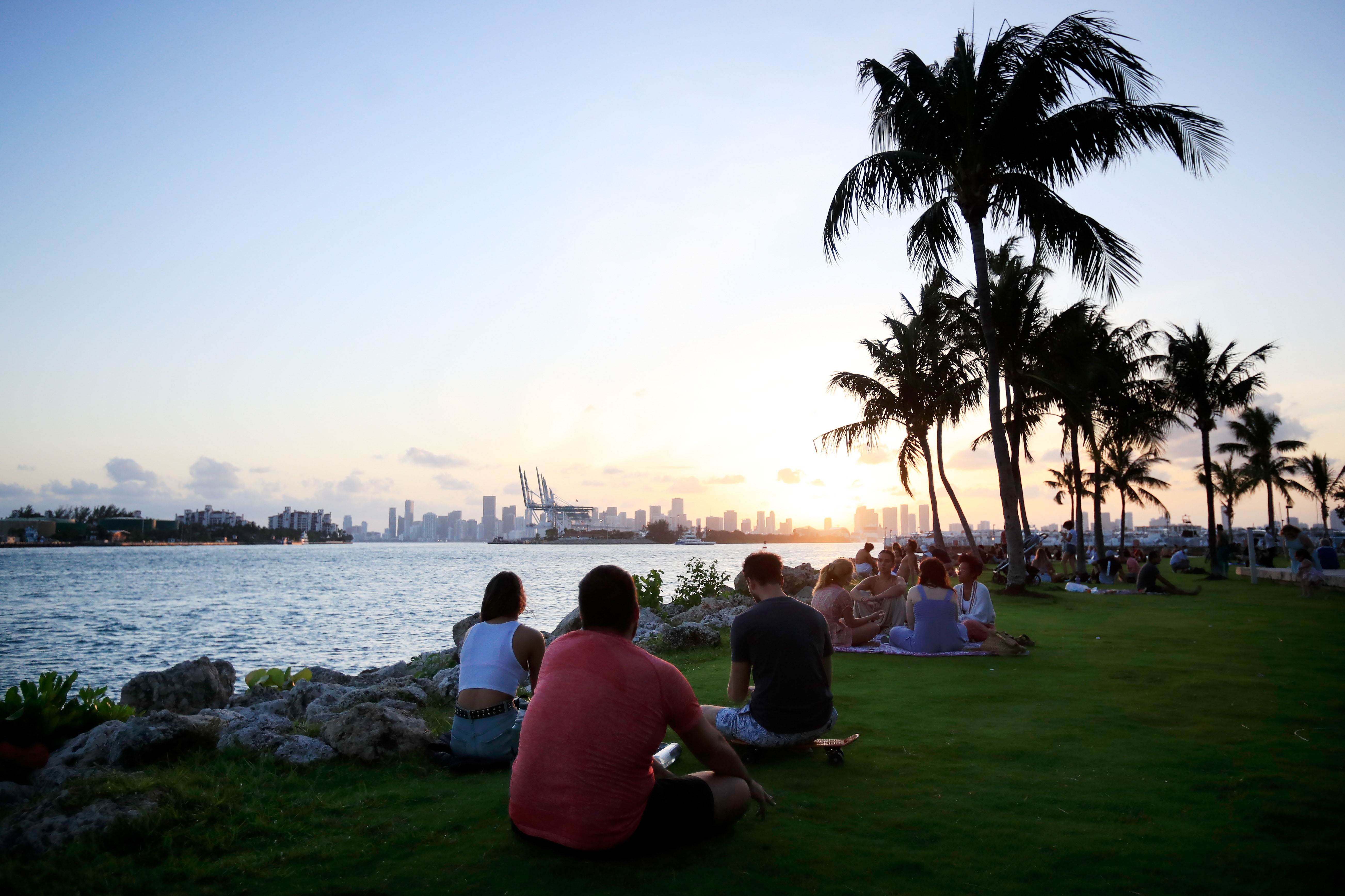 People gather for sunset in South Pointe Park on April 29 in Miami Beach, Florida.