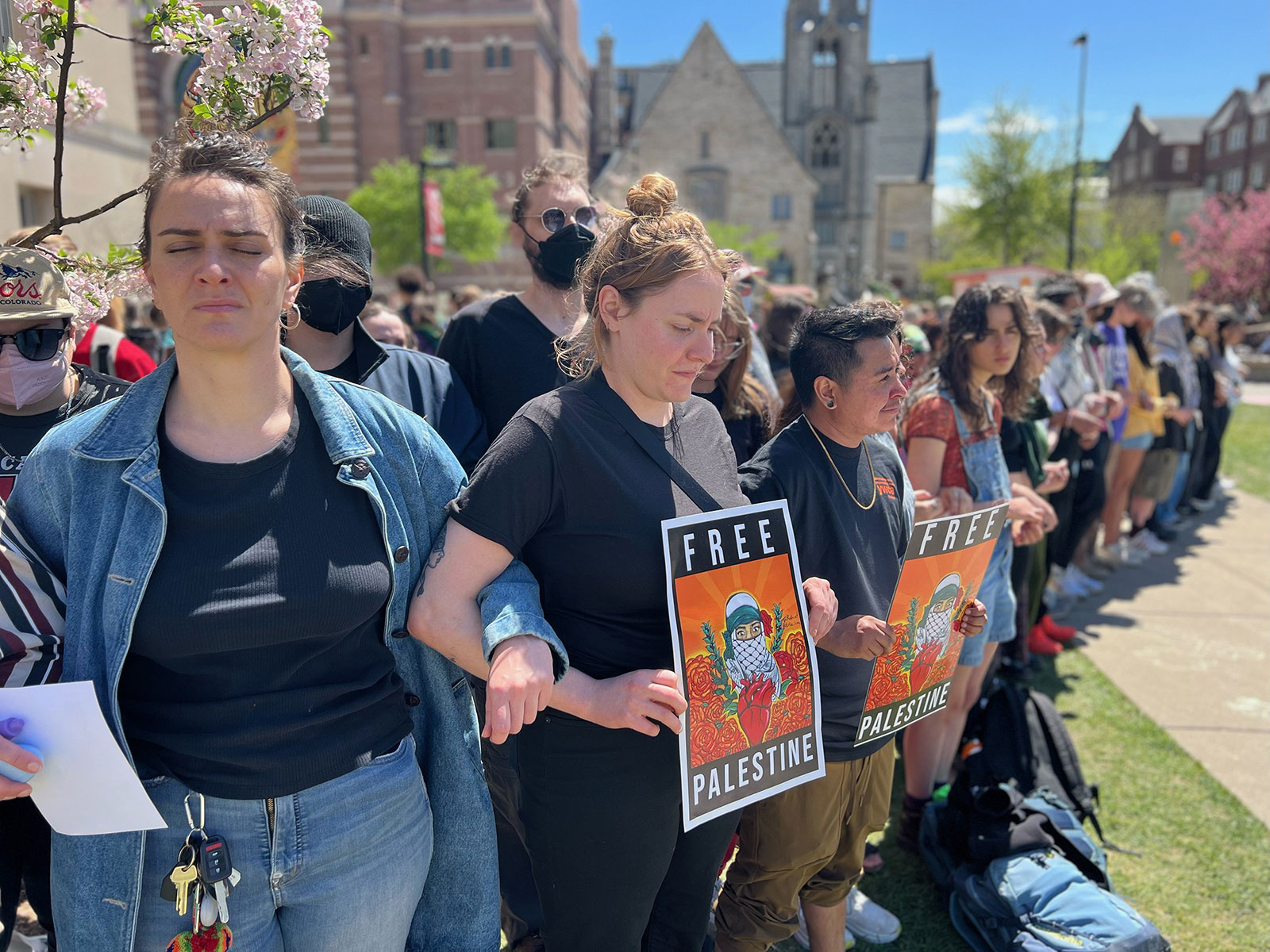 Hundreds of student protesters remain at the Library Mall Wednesday afternoon, with many holding a silent vigil with arms locked. 