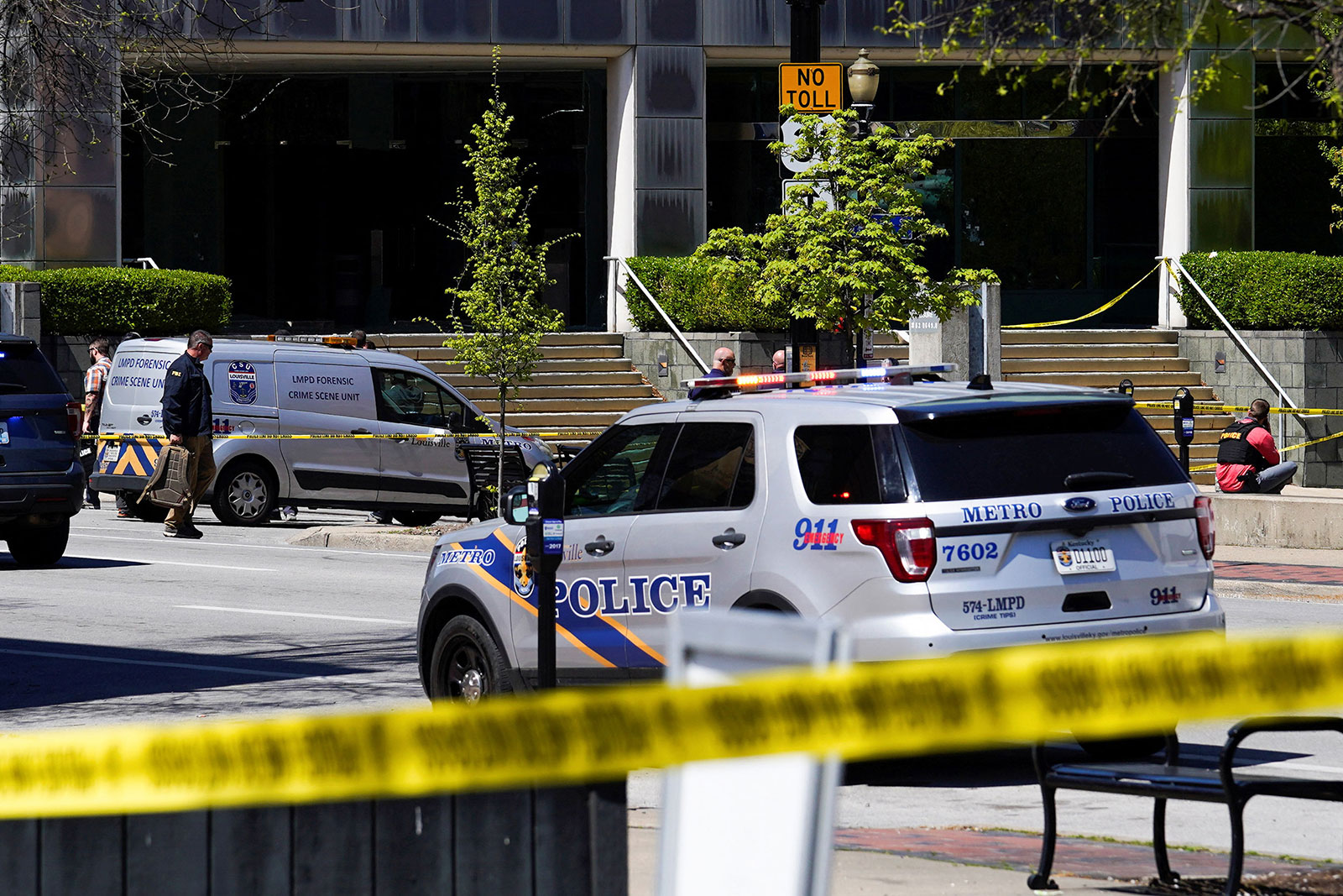 Police deploy at the scene of a shooting in downtown Louisville on Monday.
