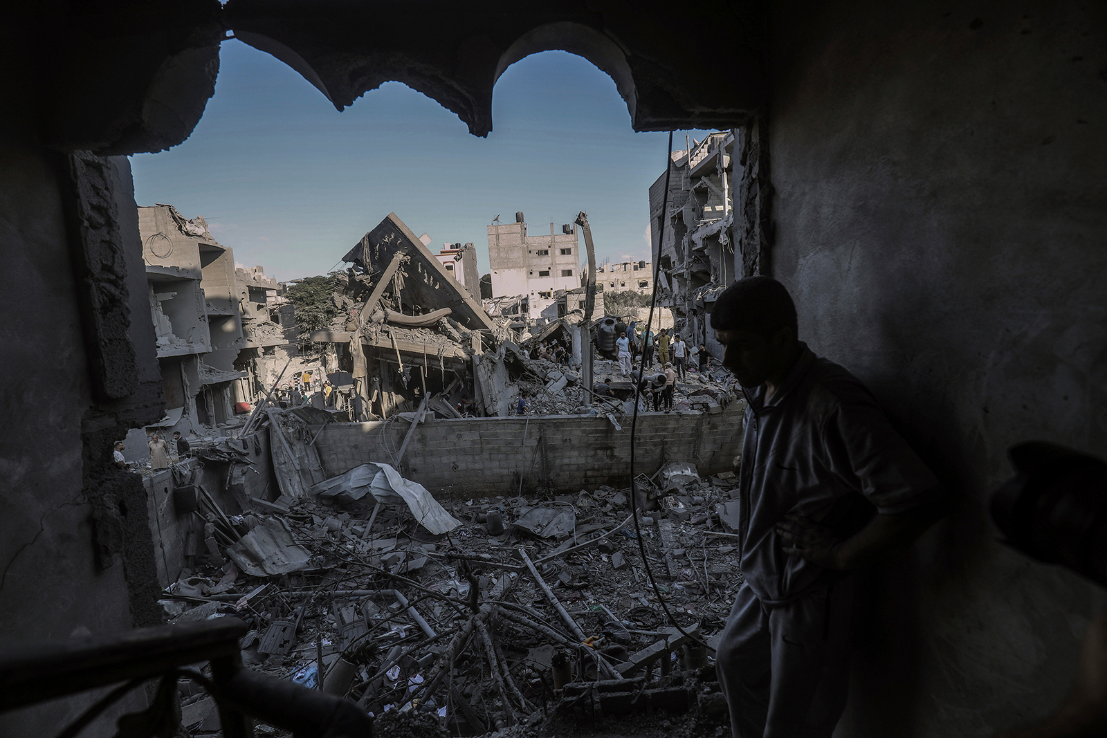 A Palestinian man inspects a destroyed house belonging to the Al-Jazzar family after an airstrike that killed eight people in Palestinian Territories, Rafah on October 18.