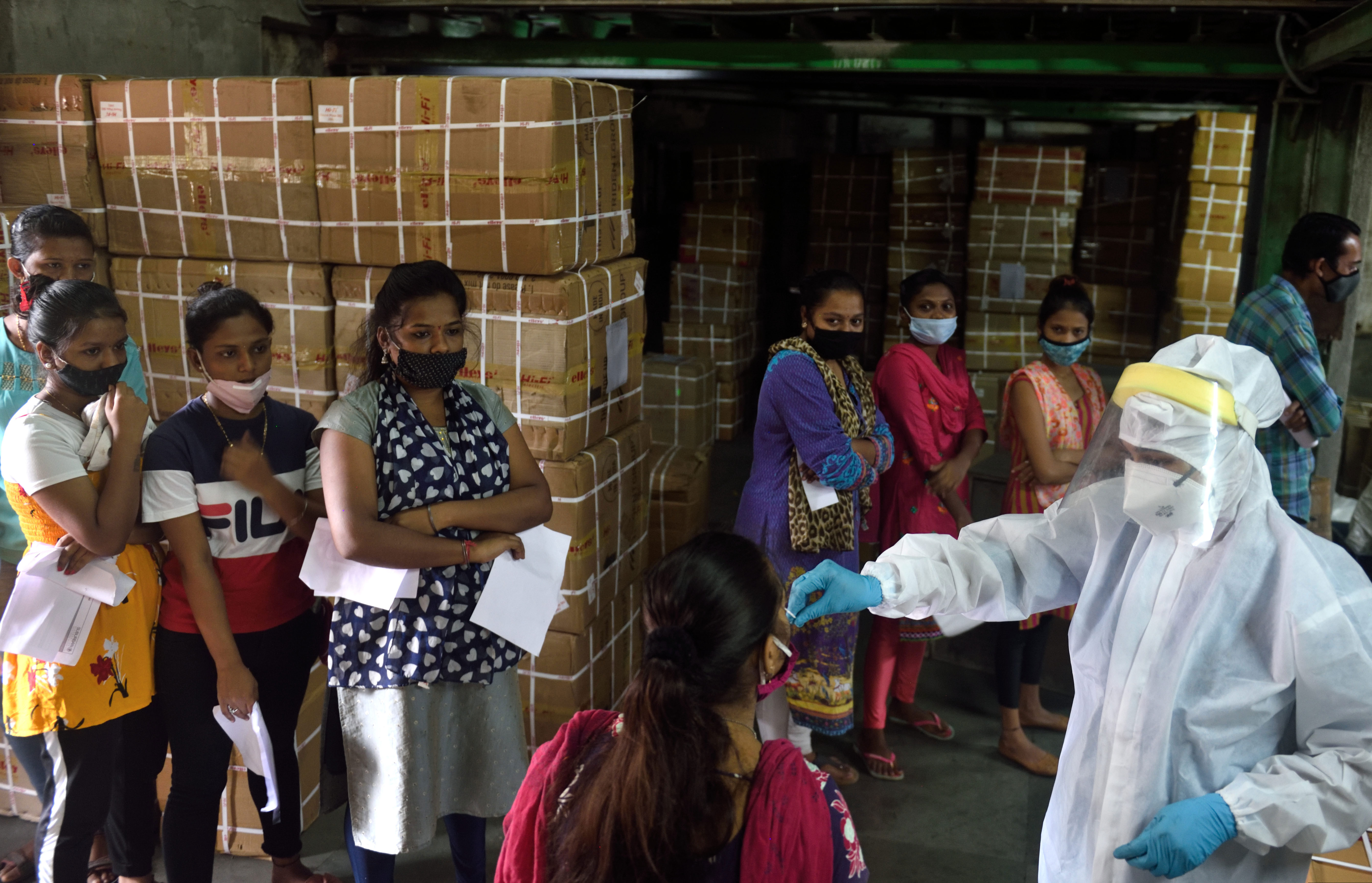 A health care worker collects a swab sample for a Covid-19 test on October 29 in Mumbai, India.