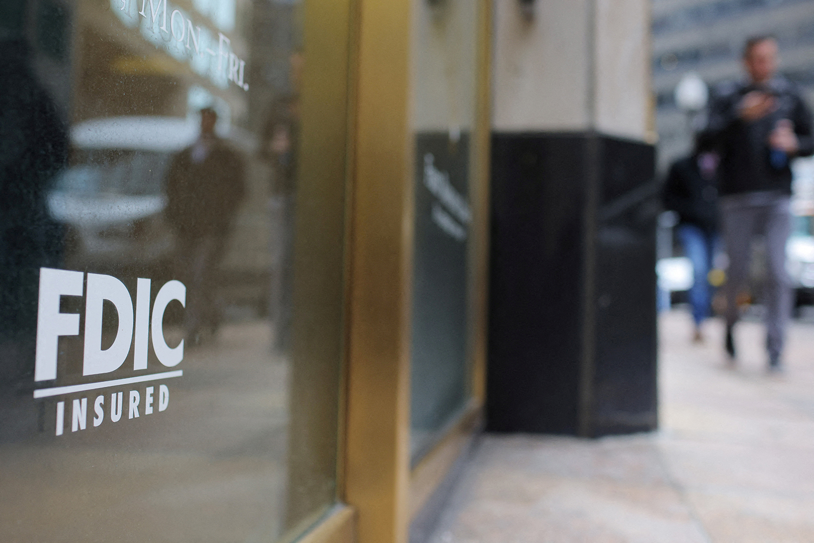 A sign reads “FDIC Insured” on the door of a branch of First Republic Bank in Boston, Massachusetts, on March 13.