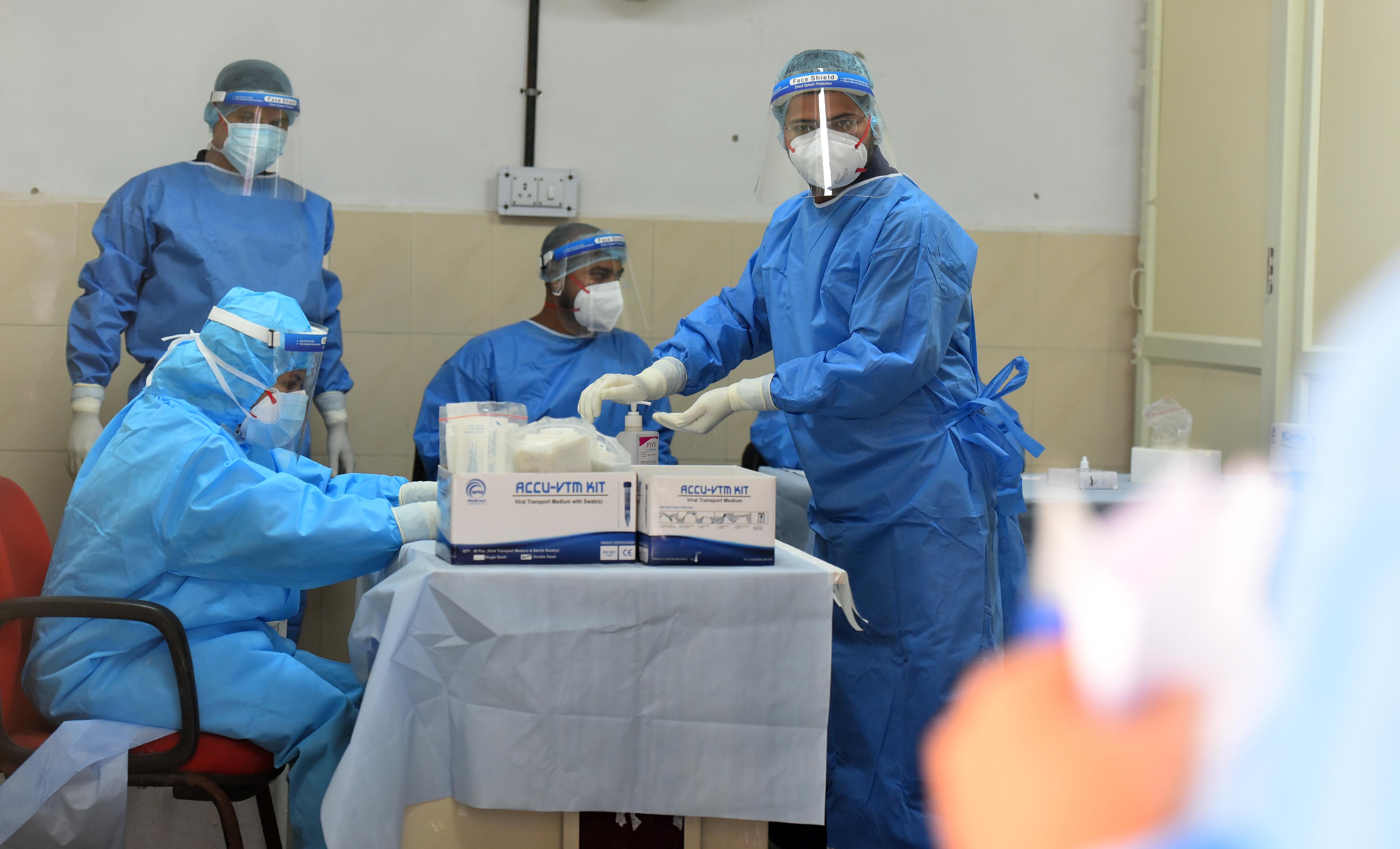 Health workers conduct coronavirus testing at Lok Nayak Jai Prakash (LNJP) Hospital, on October 23, in New Delhi. 