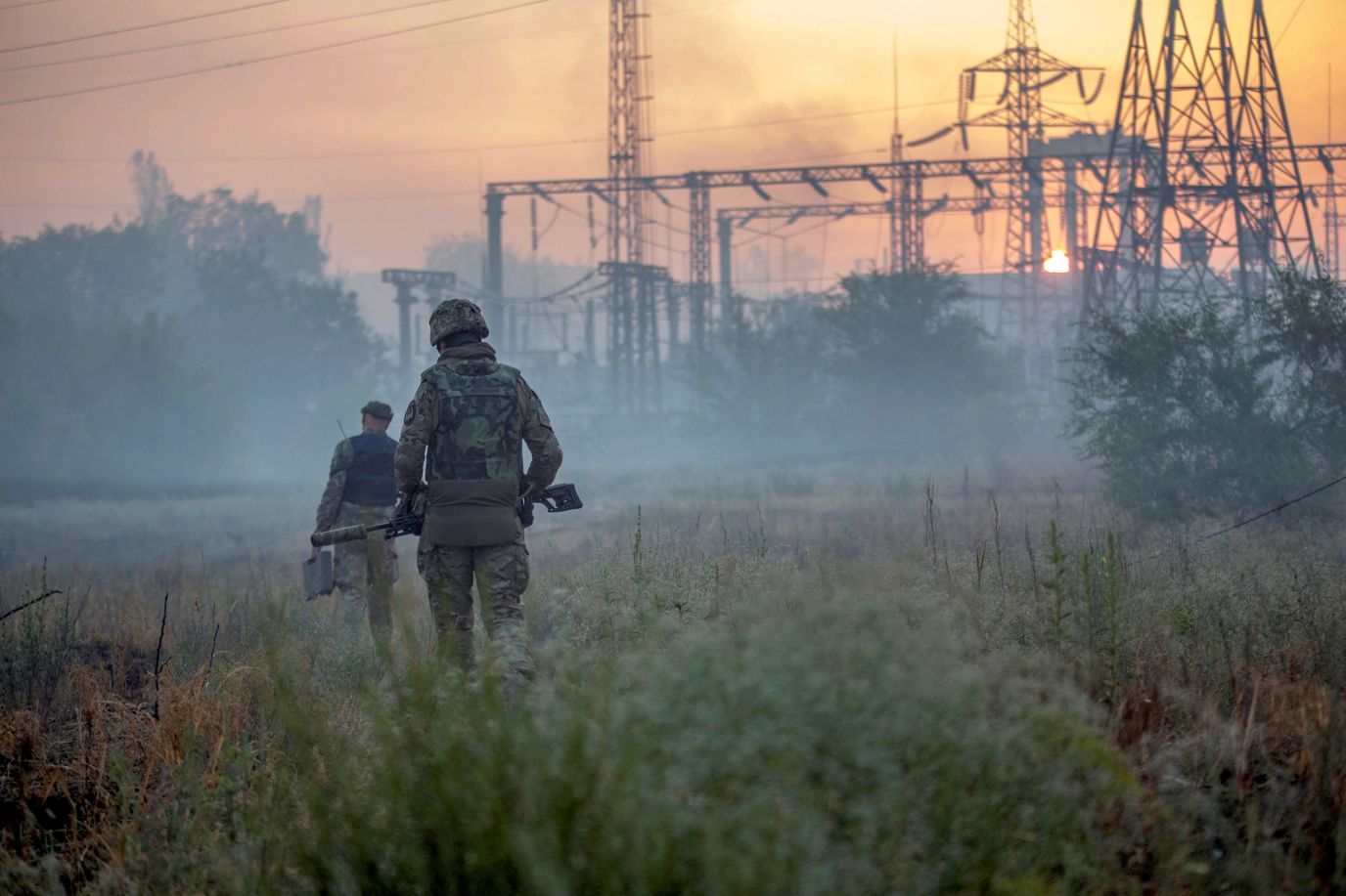 Ukrainian service members patrol an area in the city of Severodonetsk, Ukraine, on June 20, 2022.