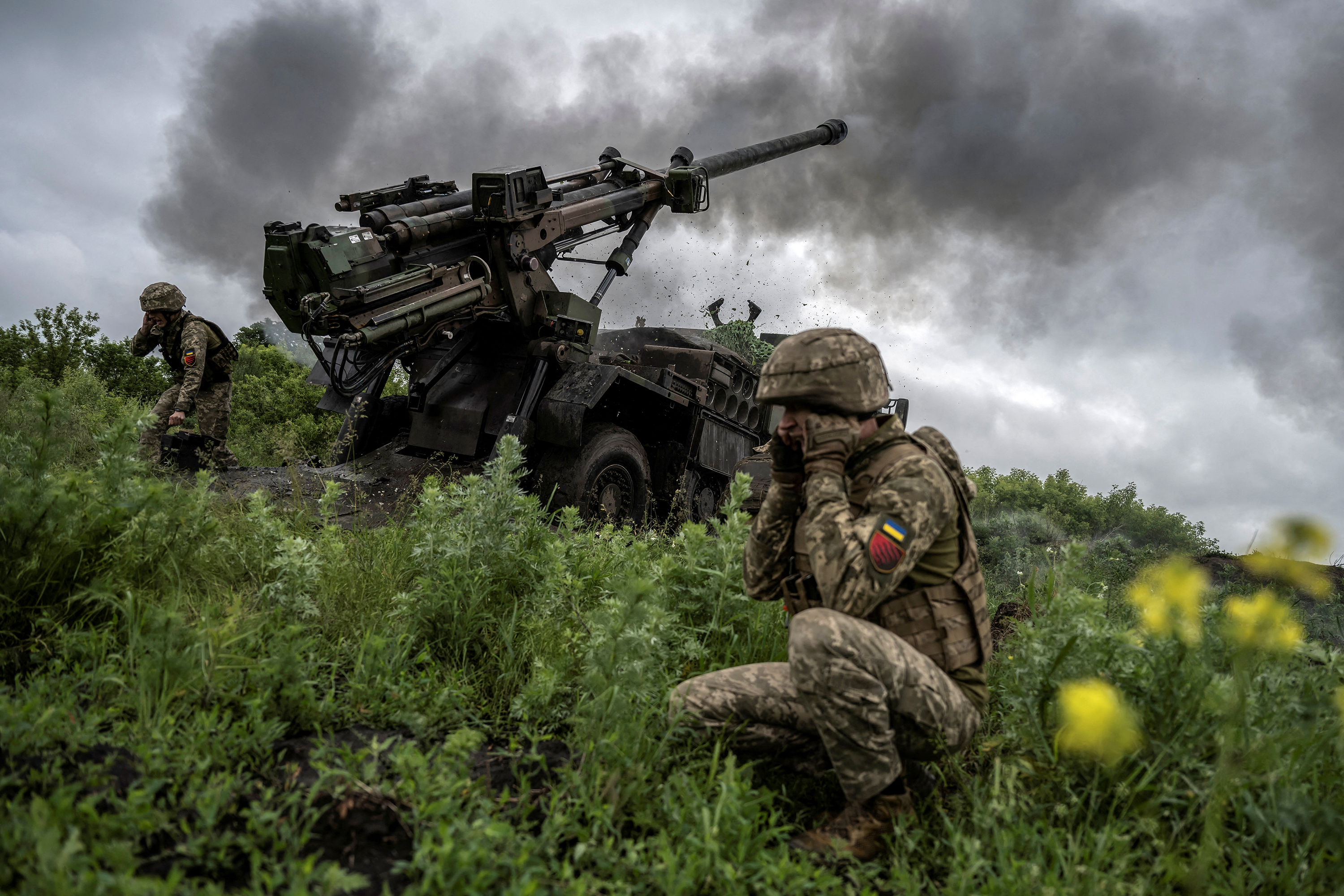 Ukrainian service members fire a howitzer near Avdiivka, Ukraine, on May 31. 
