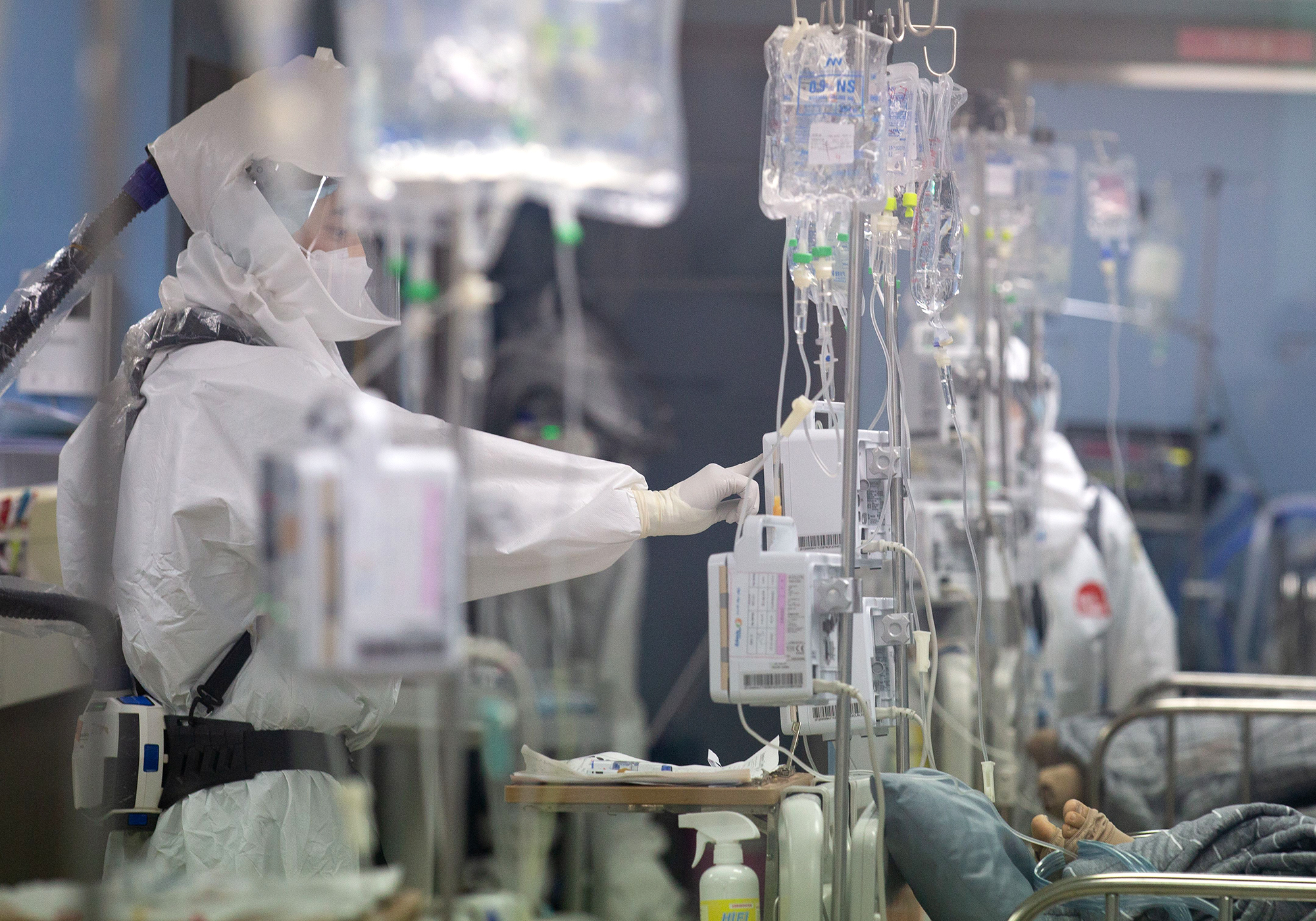 A medical worker checks on a Covid-19 patient inside the intensive care unit of the Bagae Hospital in Pyeongtaek, South Korea, on December 1. 