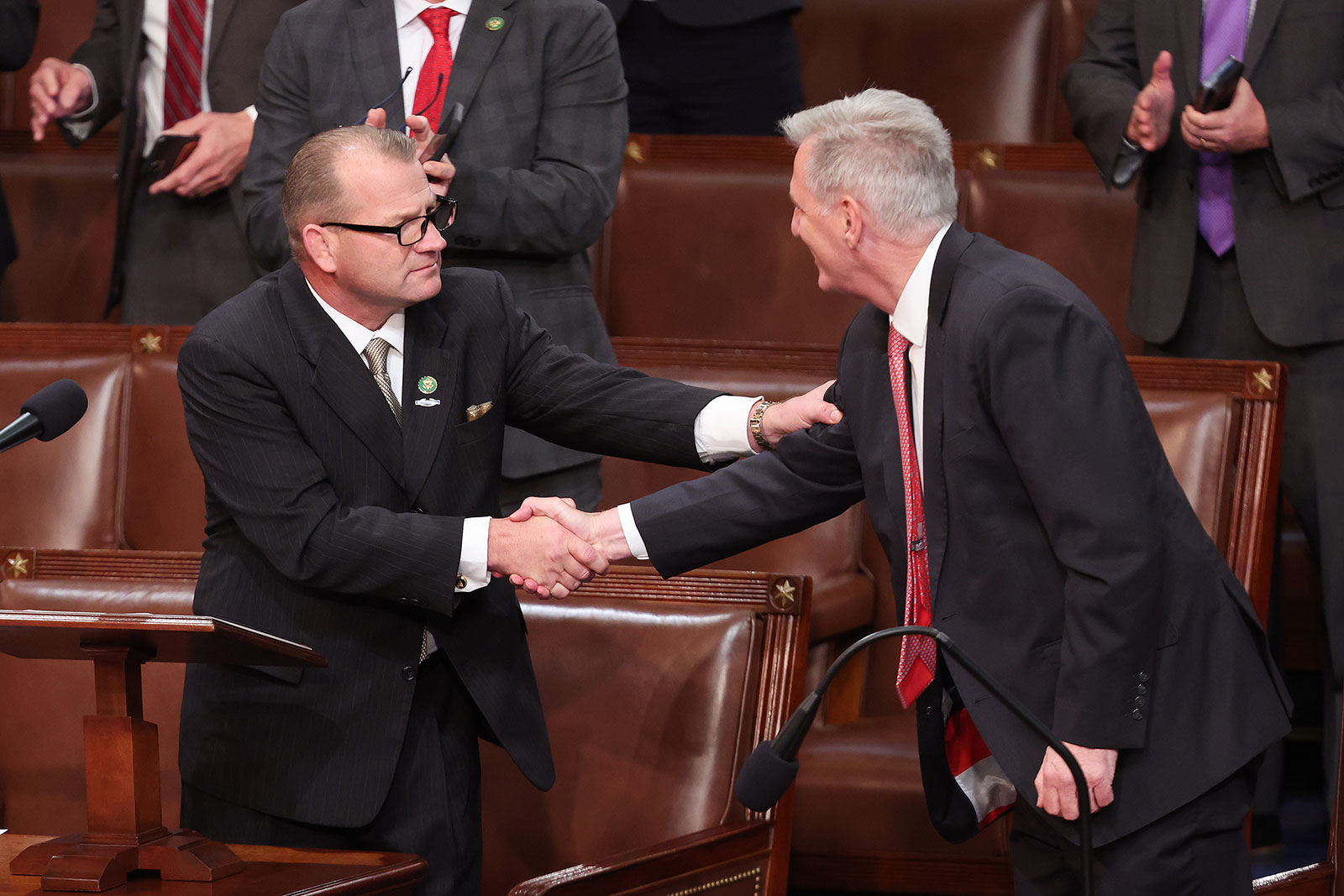Rep. Kevin McCarthy shakes hands with Rep. Troy Nehls after being nominated for a ninth round of voting.