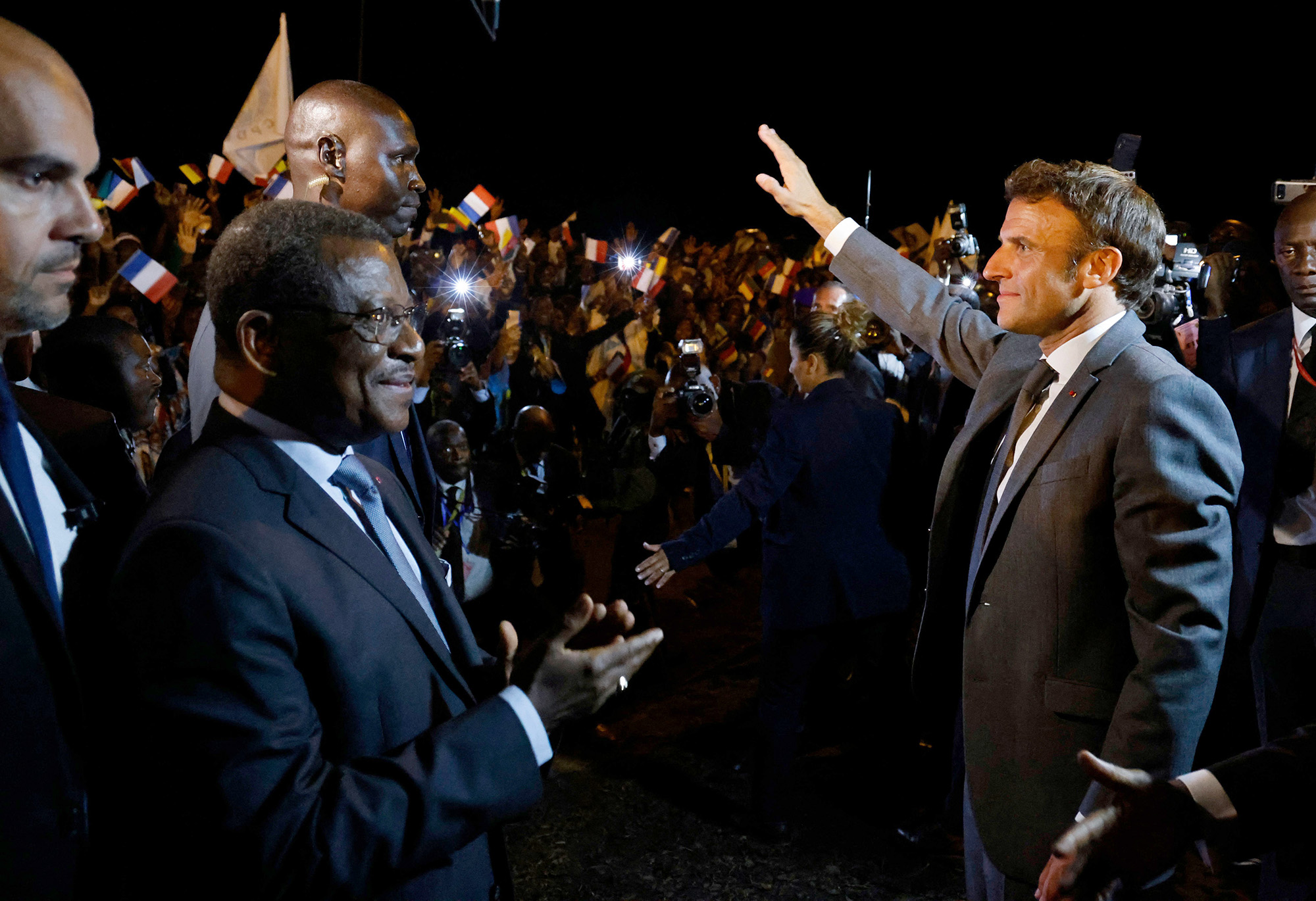 French president Emmanuel Macron waves to the crowd after being welcomed by Cameroonese Prime Minister Joseph Dion Ngute upon his arrival at the Nsimalen international airport of Yaounde, Cameroon, on July 25.