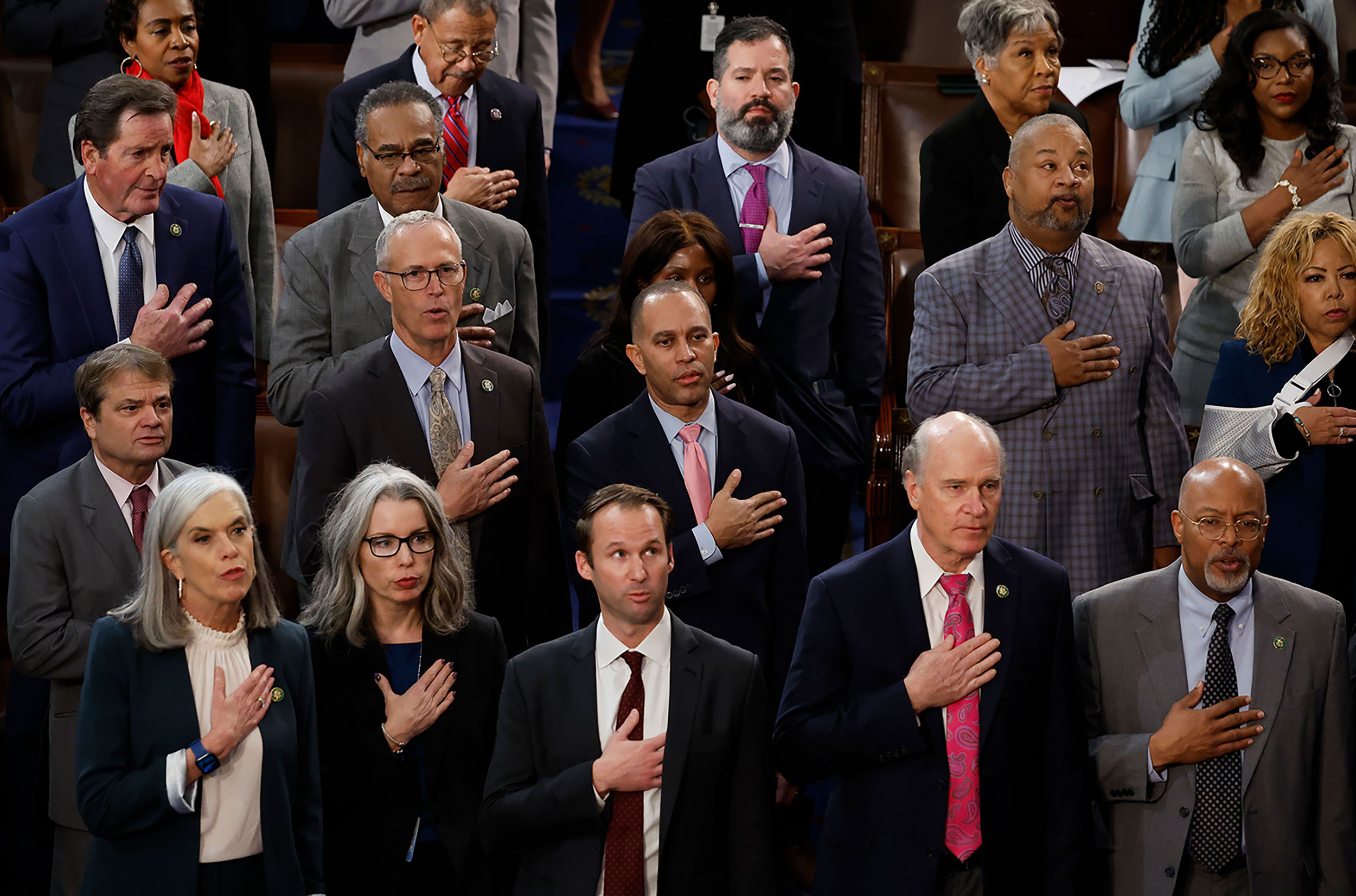 Democratic leader Hakeem Jeffries, center, and others recite the Pledge of Allegiance before the start of voting on Thursday.