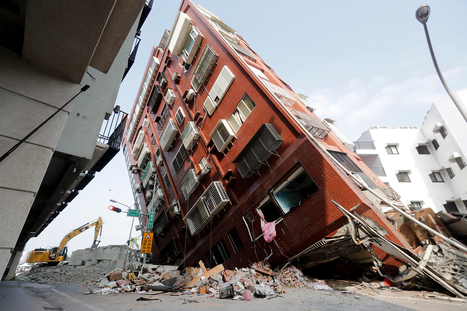 Debris surrounds a titled building a day after a powerful earthquake struck, in Hualien City, Taiwan, on Thursday.