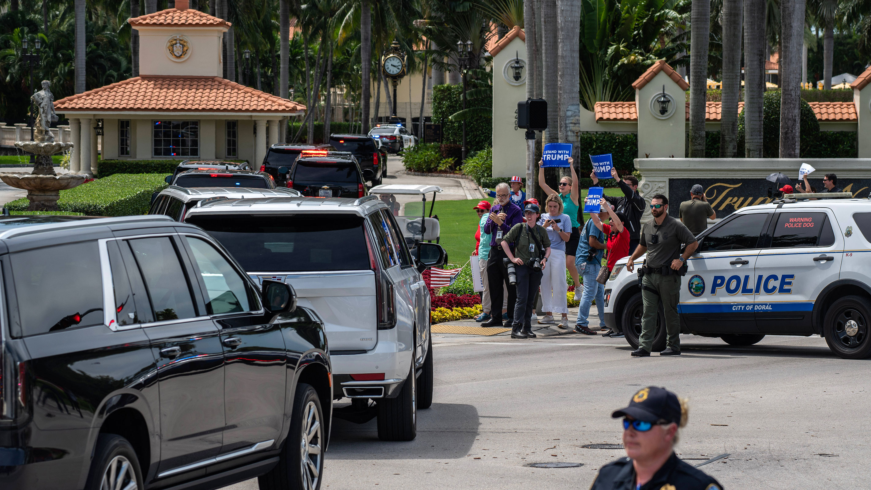 The motorcade for former President Donald Trump passes supporters outside Trump National Doral Golf Club in Doral, Florida, on Monday, June 12.