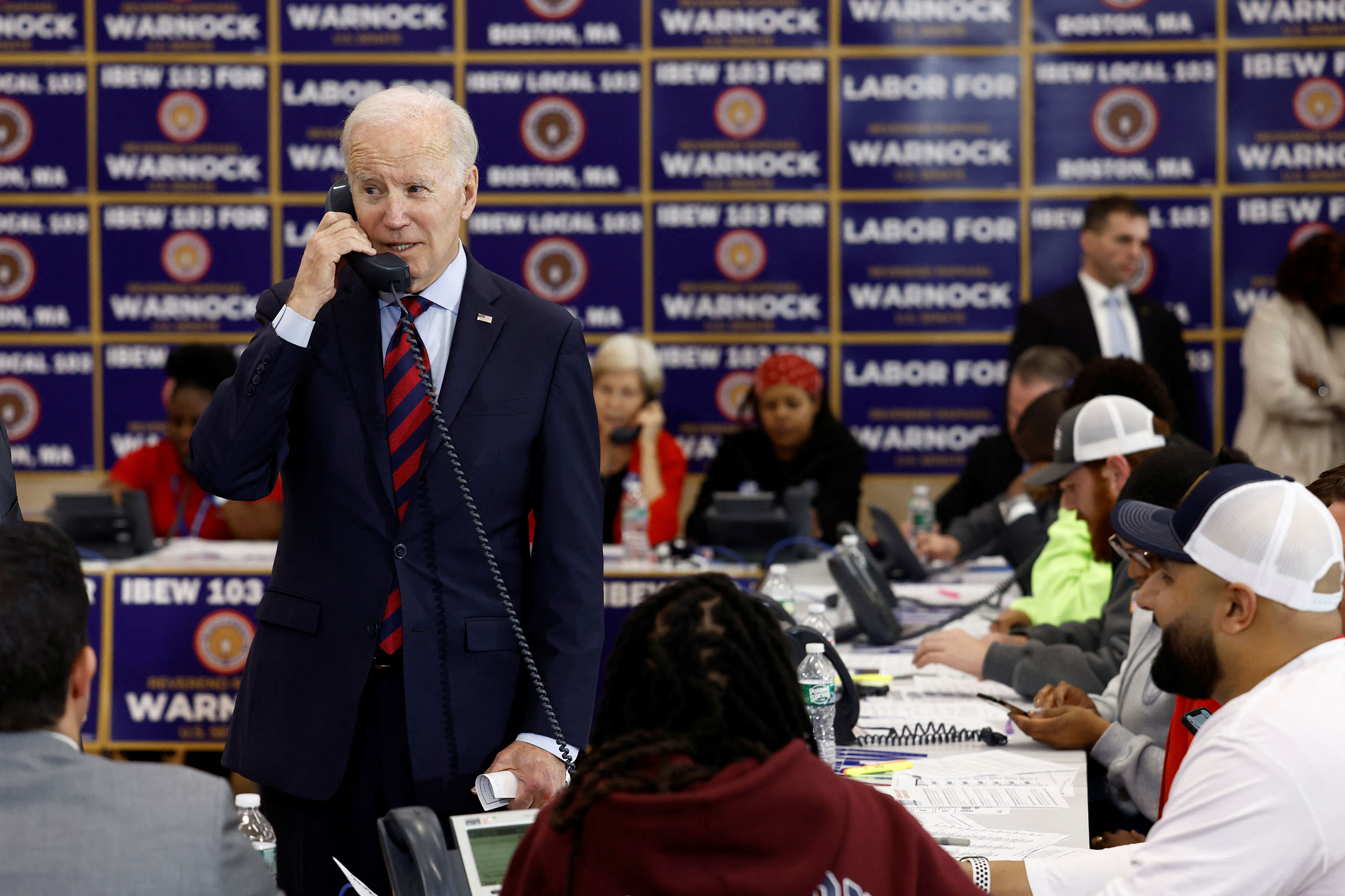 President Joe Biden takes part in an International Brotherhood of Electrical Workers phone bank for Senator Raphael Warnock in Boston on Friday.
