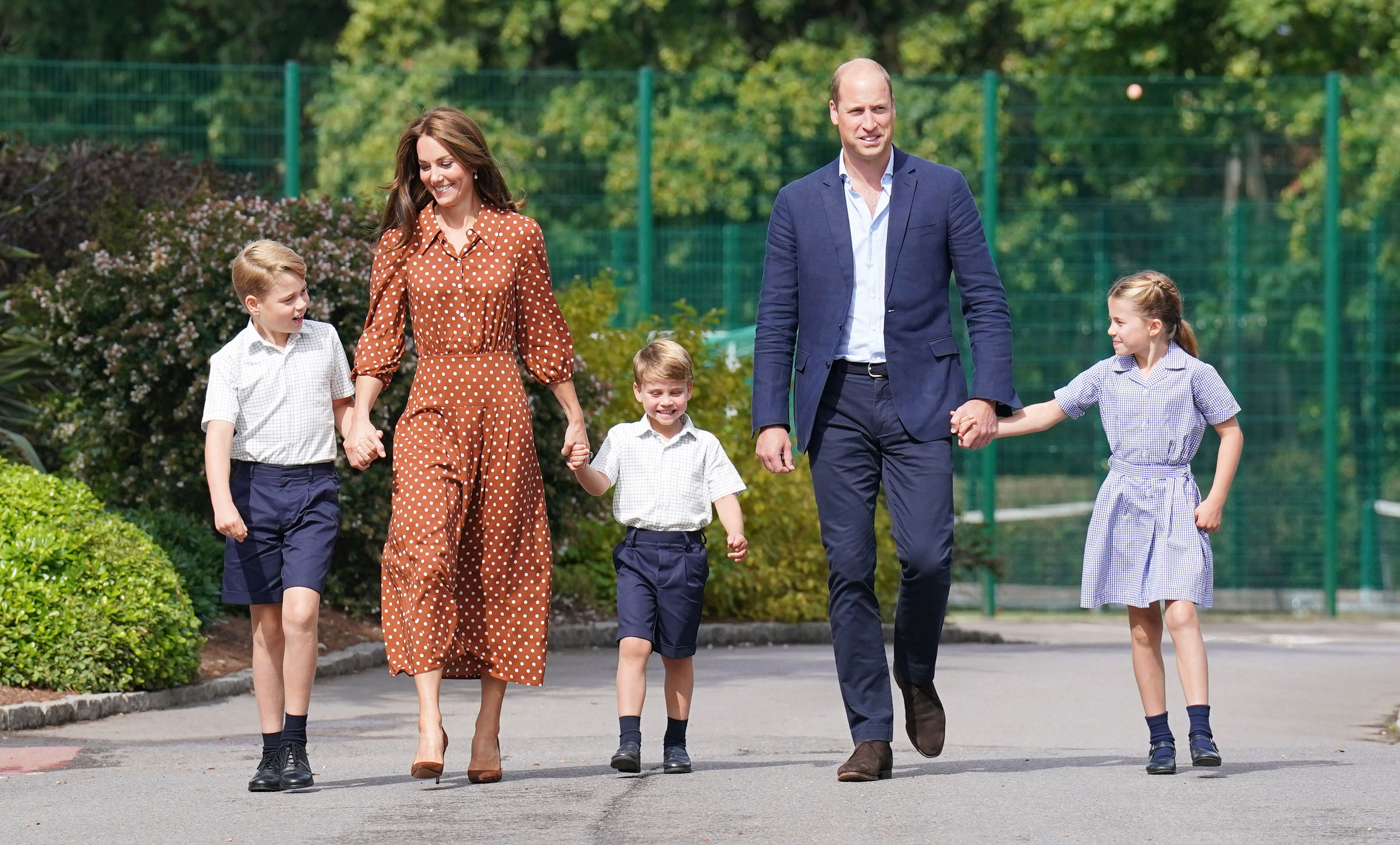 Prince George, left, Prince Louis, center, and Princess Charlotte are accompanied by their parents Prince William and Catherine as they arrive at Lambrook School on September 7 in Bracknell, England.