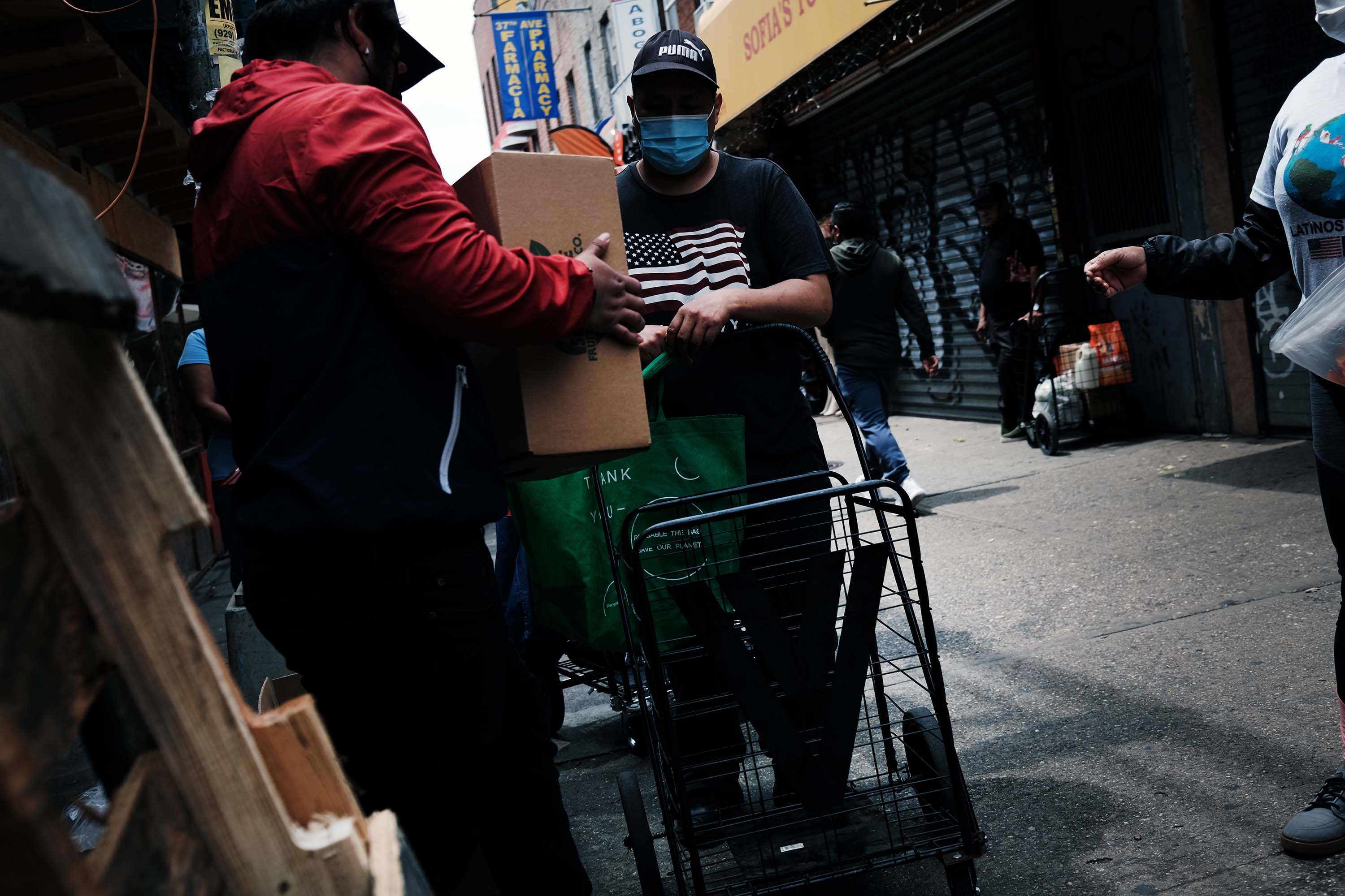 People receive food from a local charity in the Queens borough of New York City on June 4.