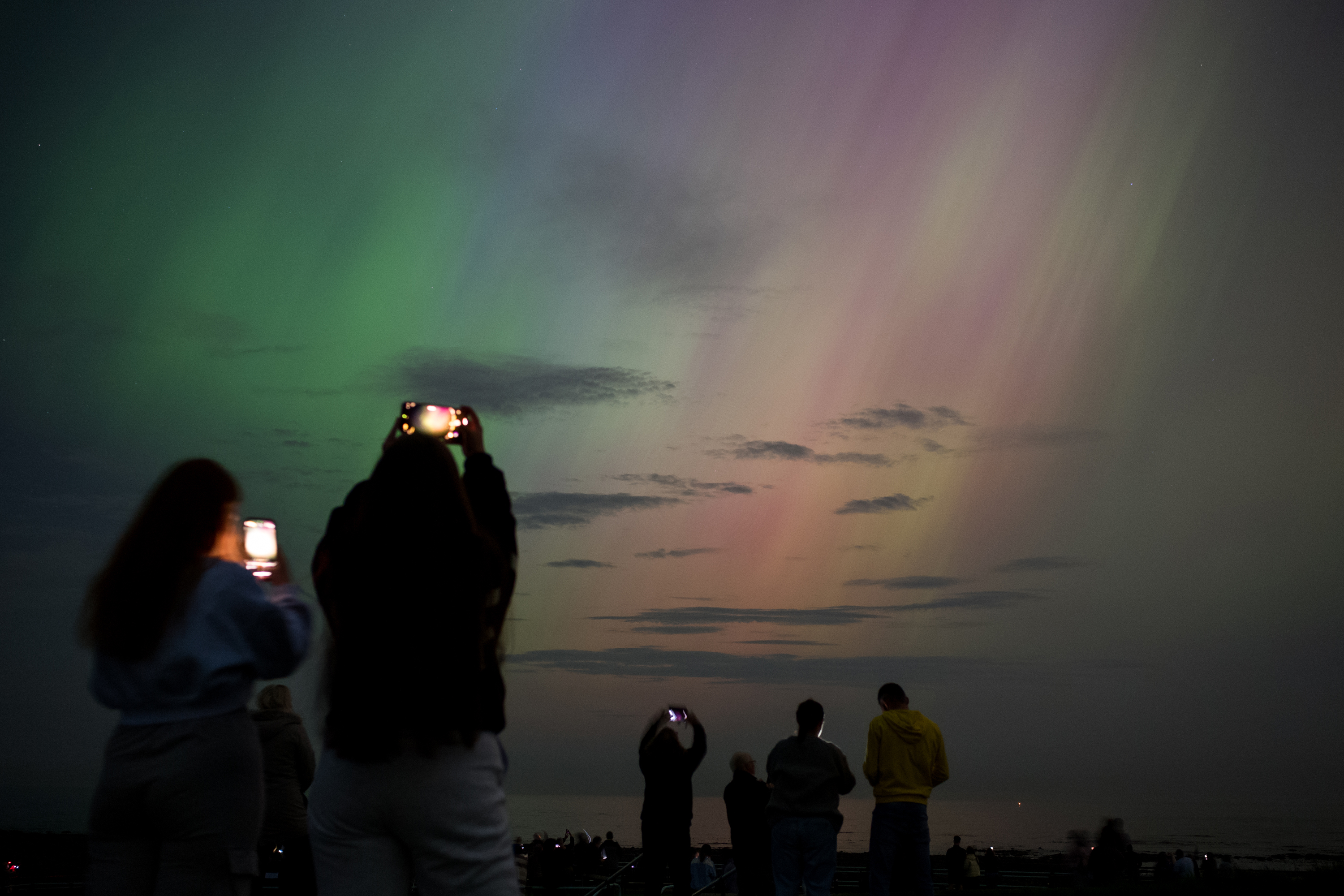 People visit St Mary's lighthouse to see the aurora borealis, in Whitley Bay, England, on May 10.