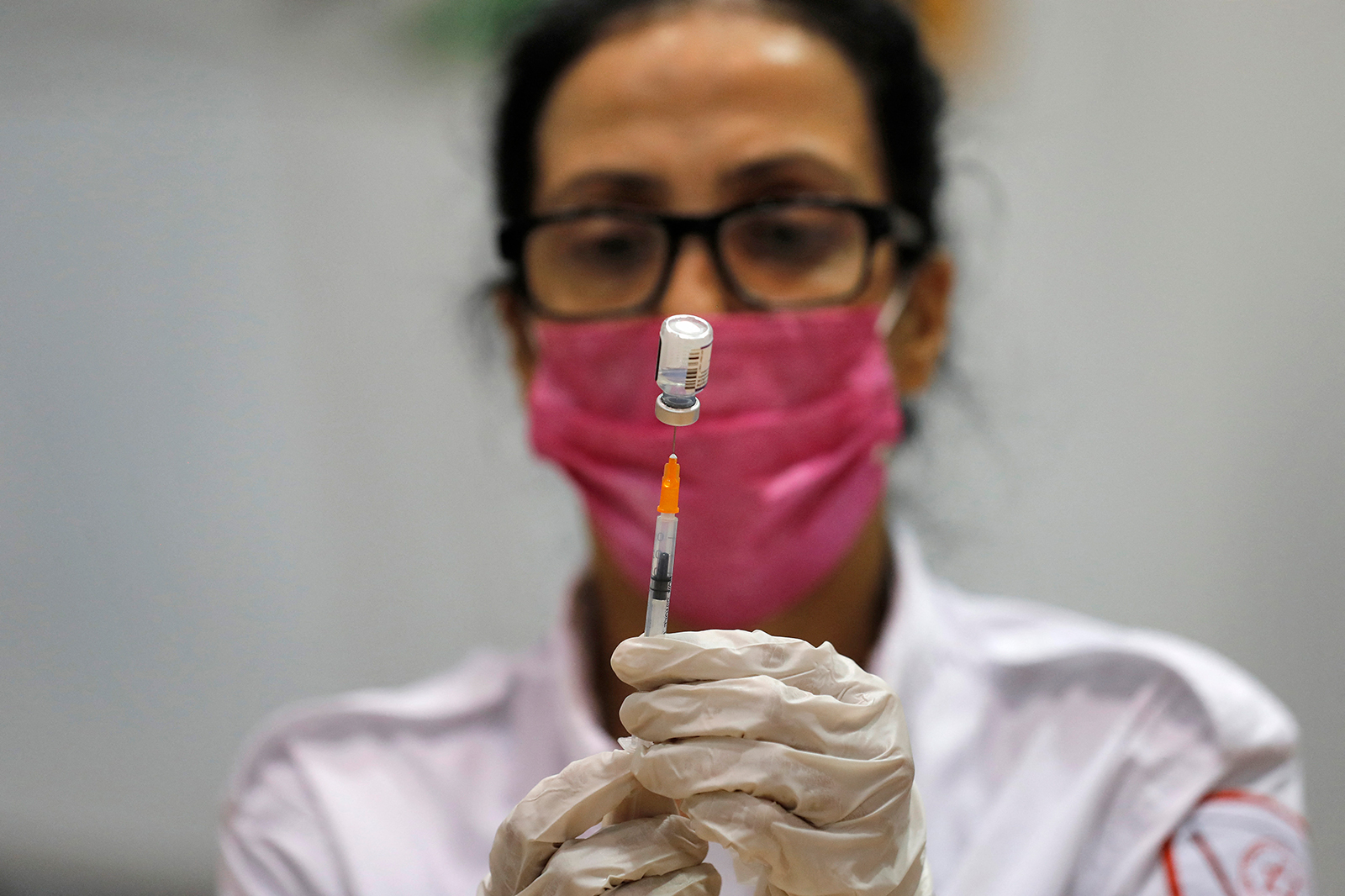 A paramedic prepares to administer the third shot of the a Covid-19 vaccine on August 24, in Holon, Israel.