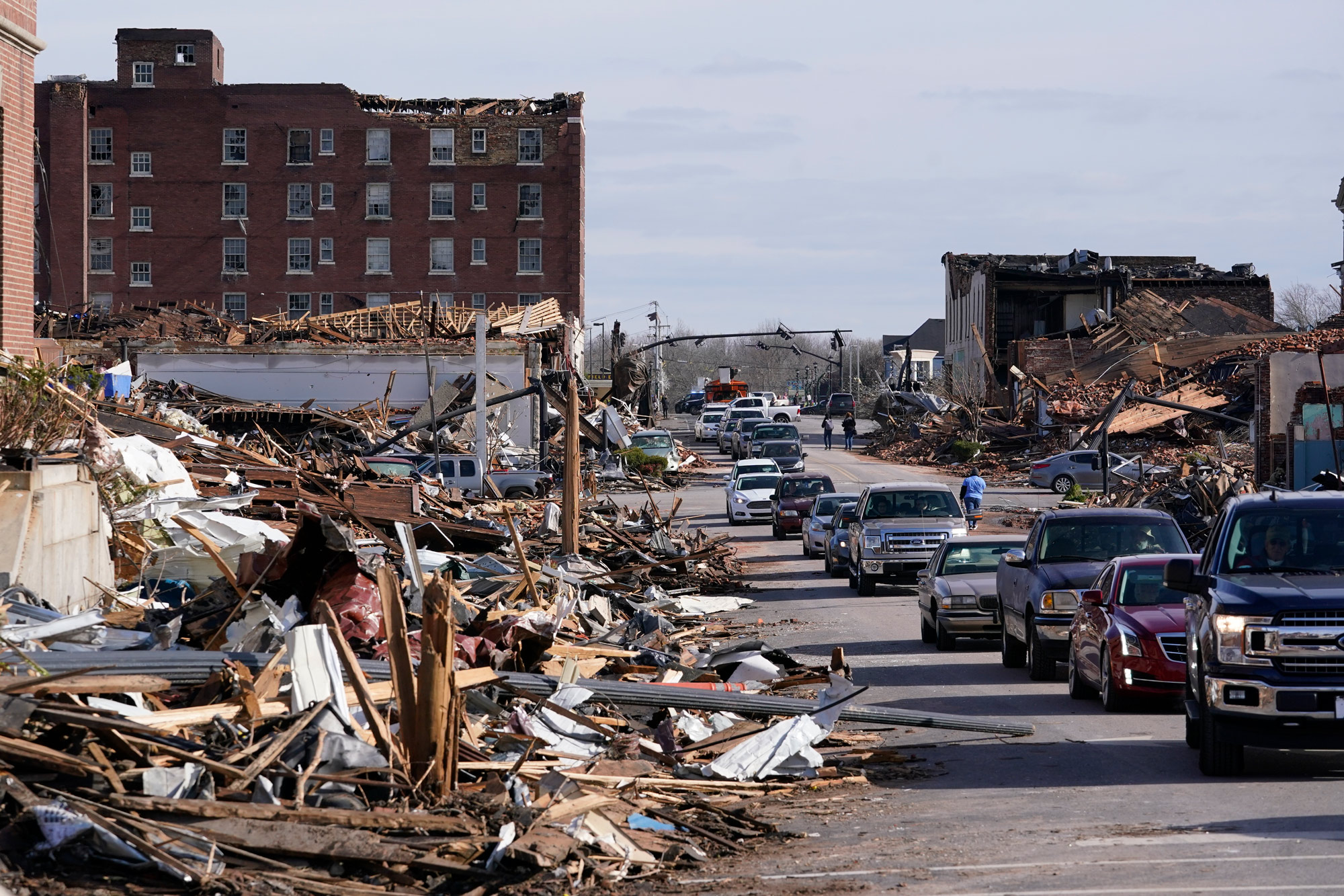People survey storm damage in Mayfield, Kentucky, on December 11.