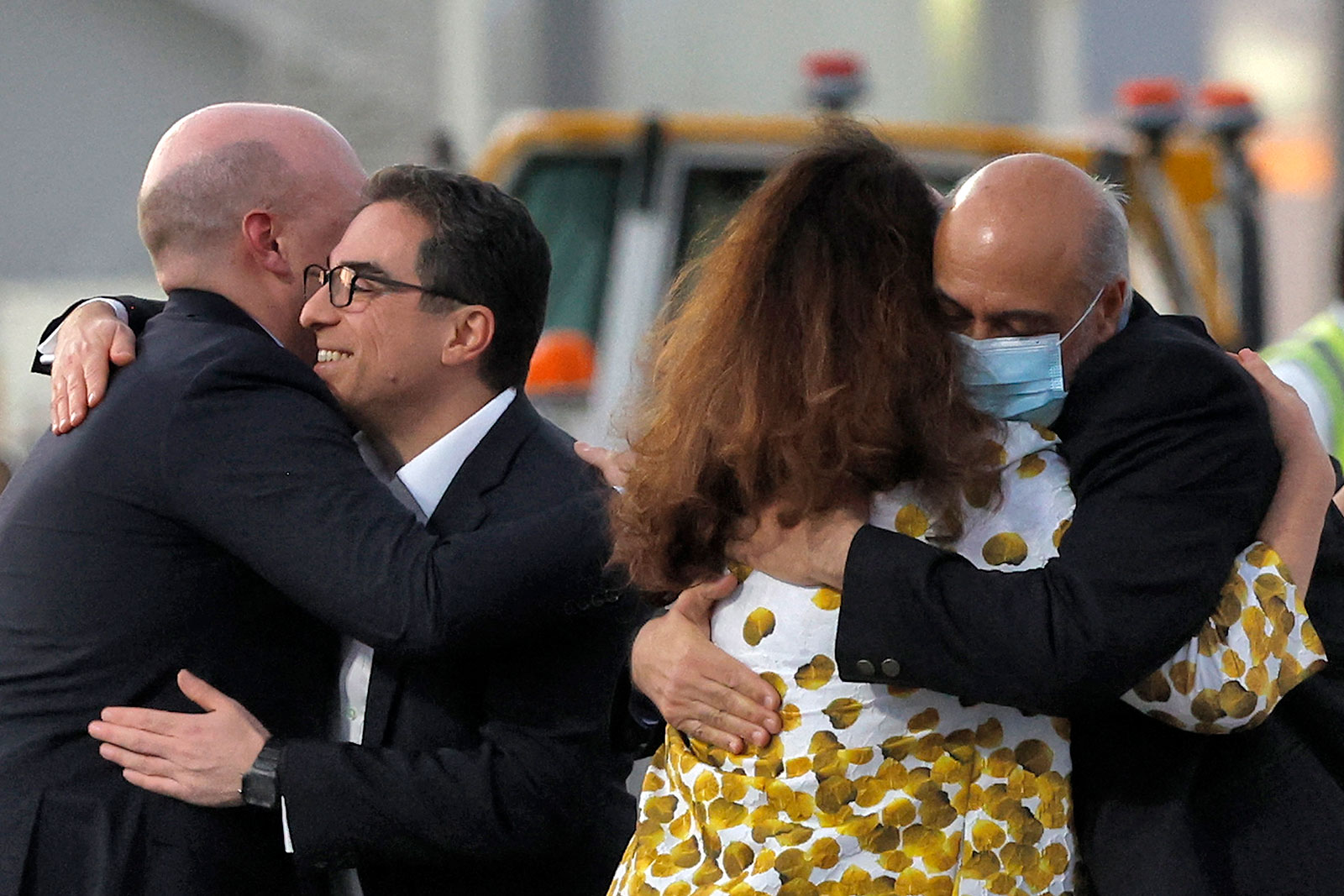 US citizens Siamak Namazi, second from left, and Morad Tahbaz, right, are embraced after disembarking from a jet in Doha, Qatar, on Monday, September 18.
