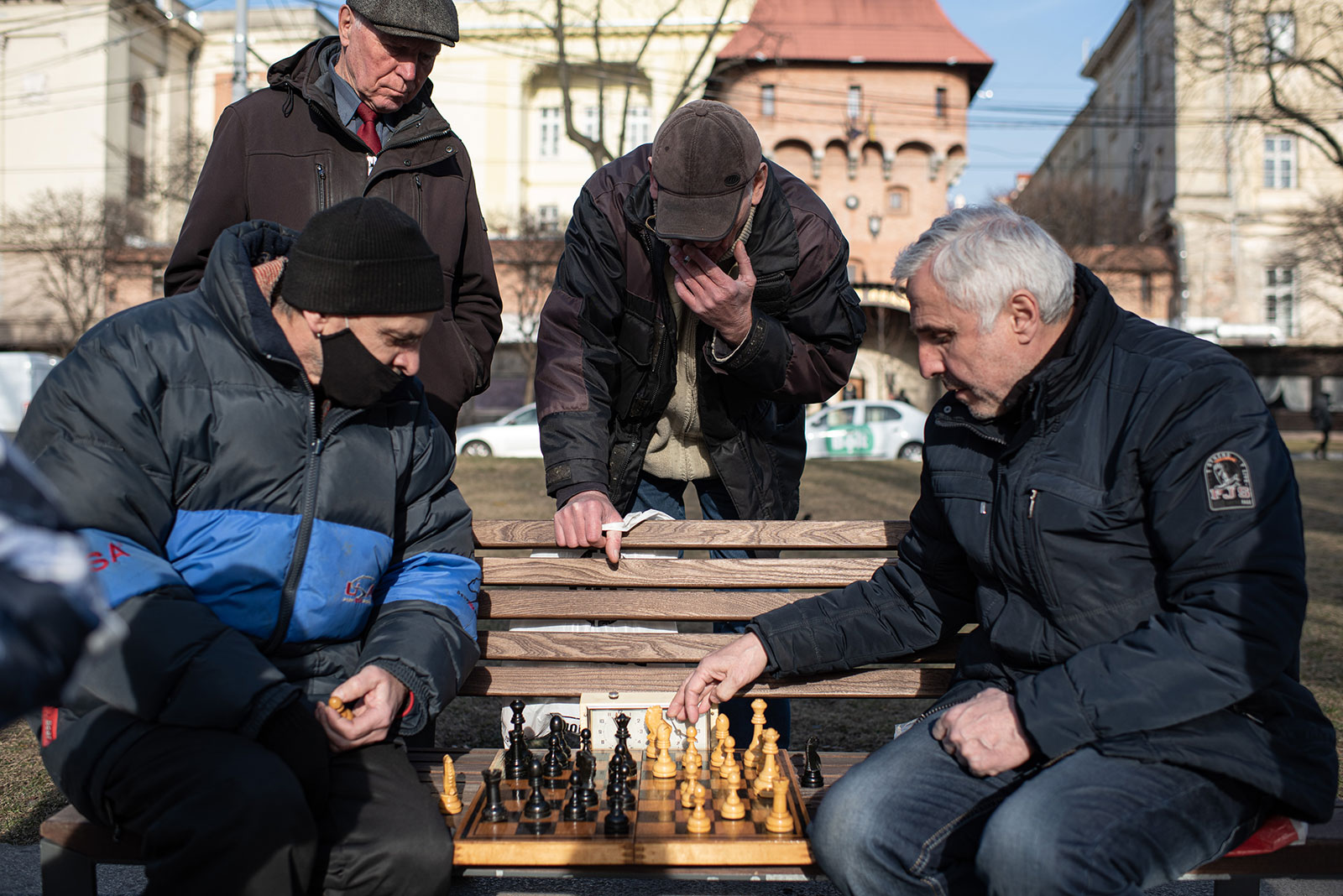 Men play chess on a bench in the boulevard leading to the Lviv Opera House on March 20. 