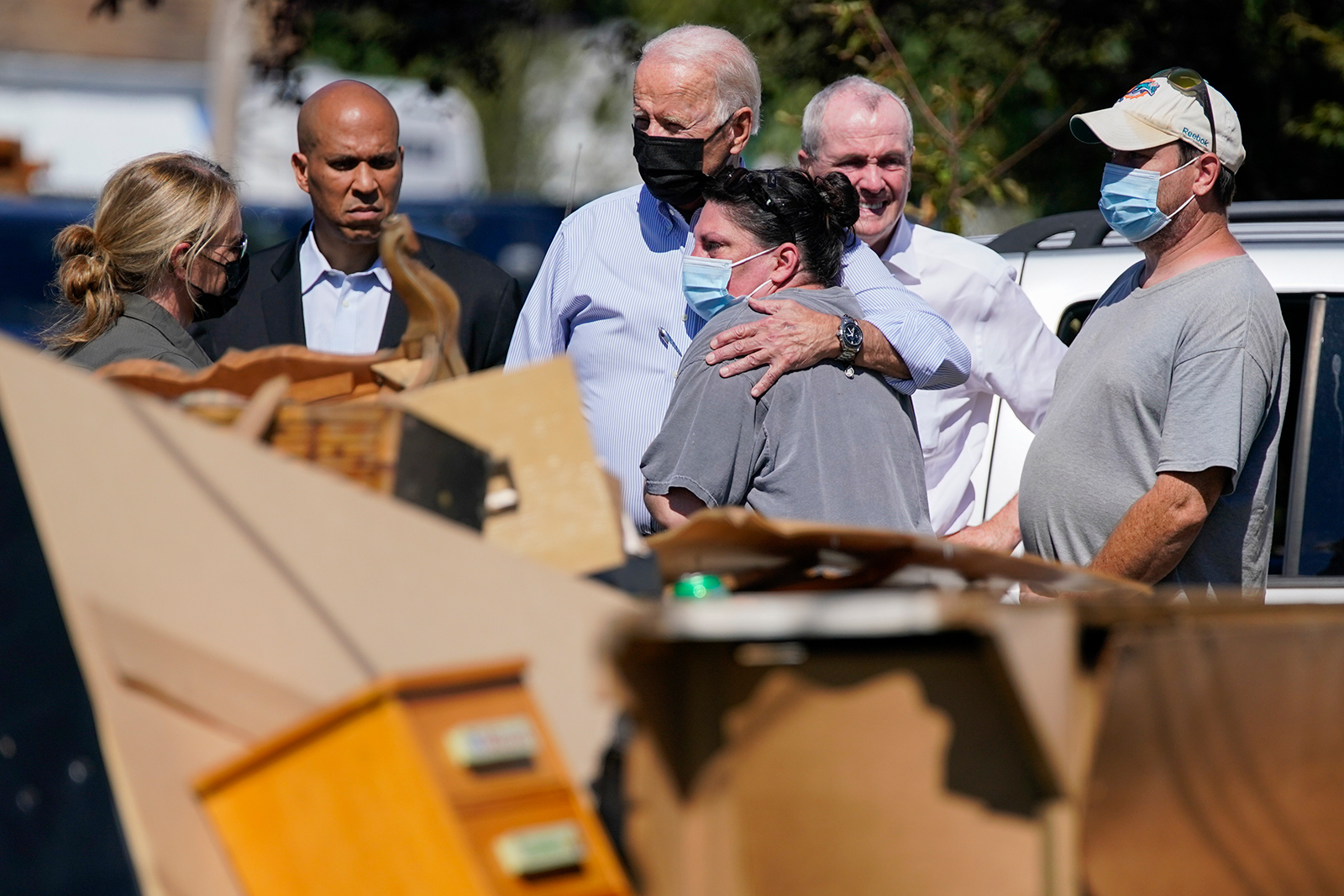 President Joe Biden hugs a person as he tours a neighborhood impacted by Hurricane Ida, on Tuesday, September 7 in Manville, New Jersey.