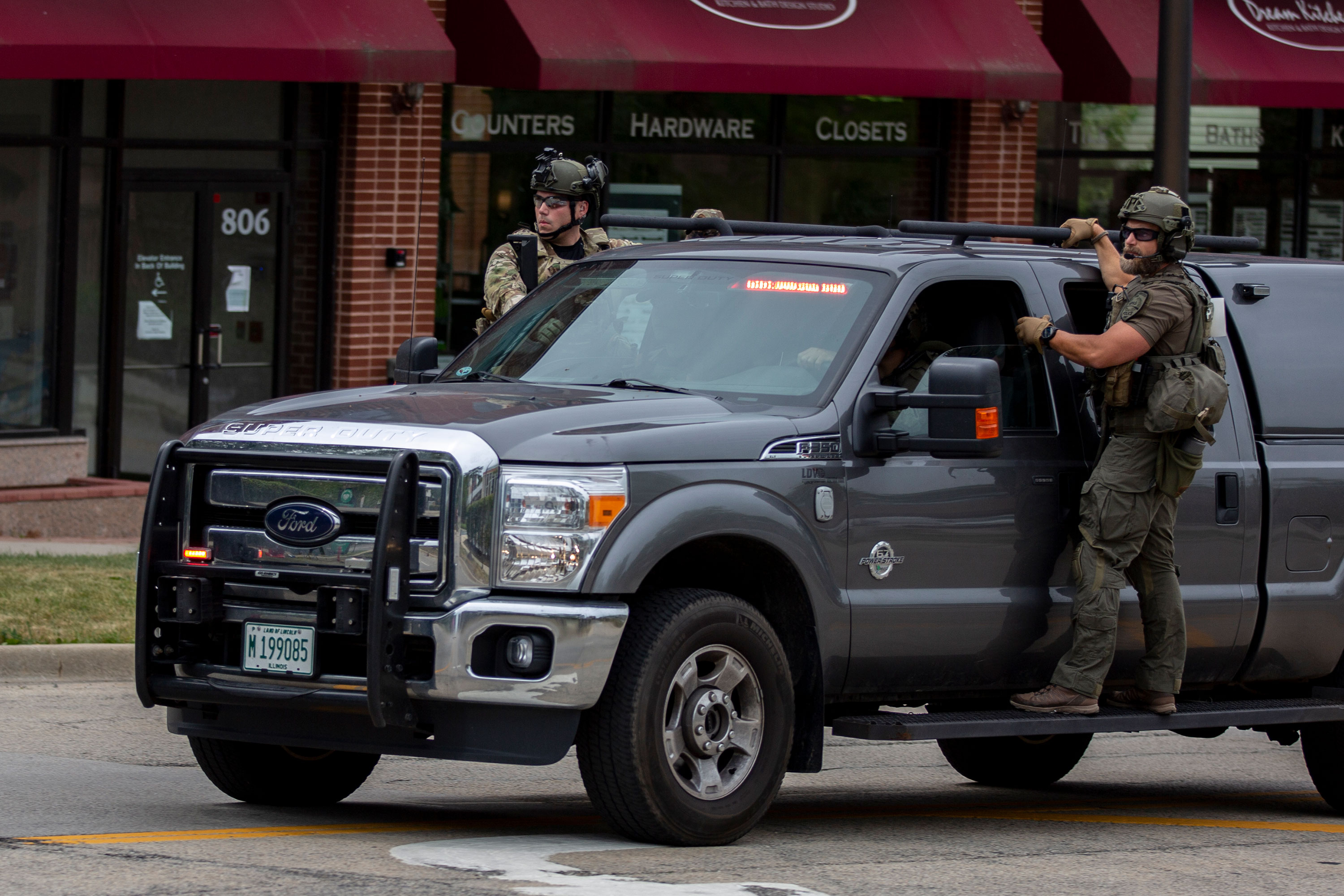 Police respond at the scene of the shooting in Highland Park, Illinois, on Monday.