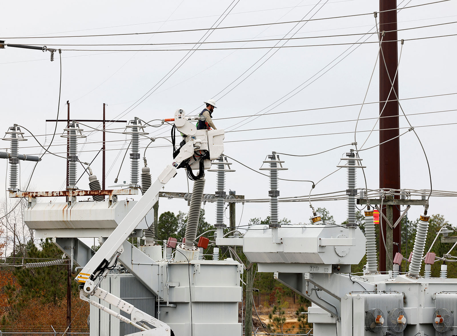 Duke Energy personnel work to restore power at an electrical substation in Carthage, North Carolina, on December 4.