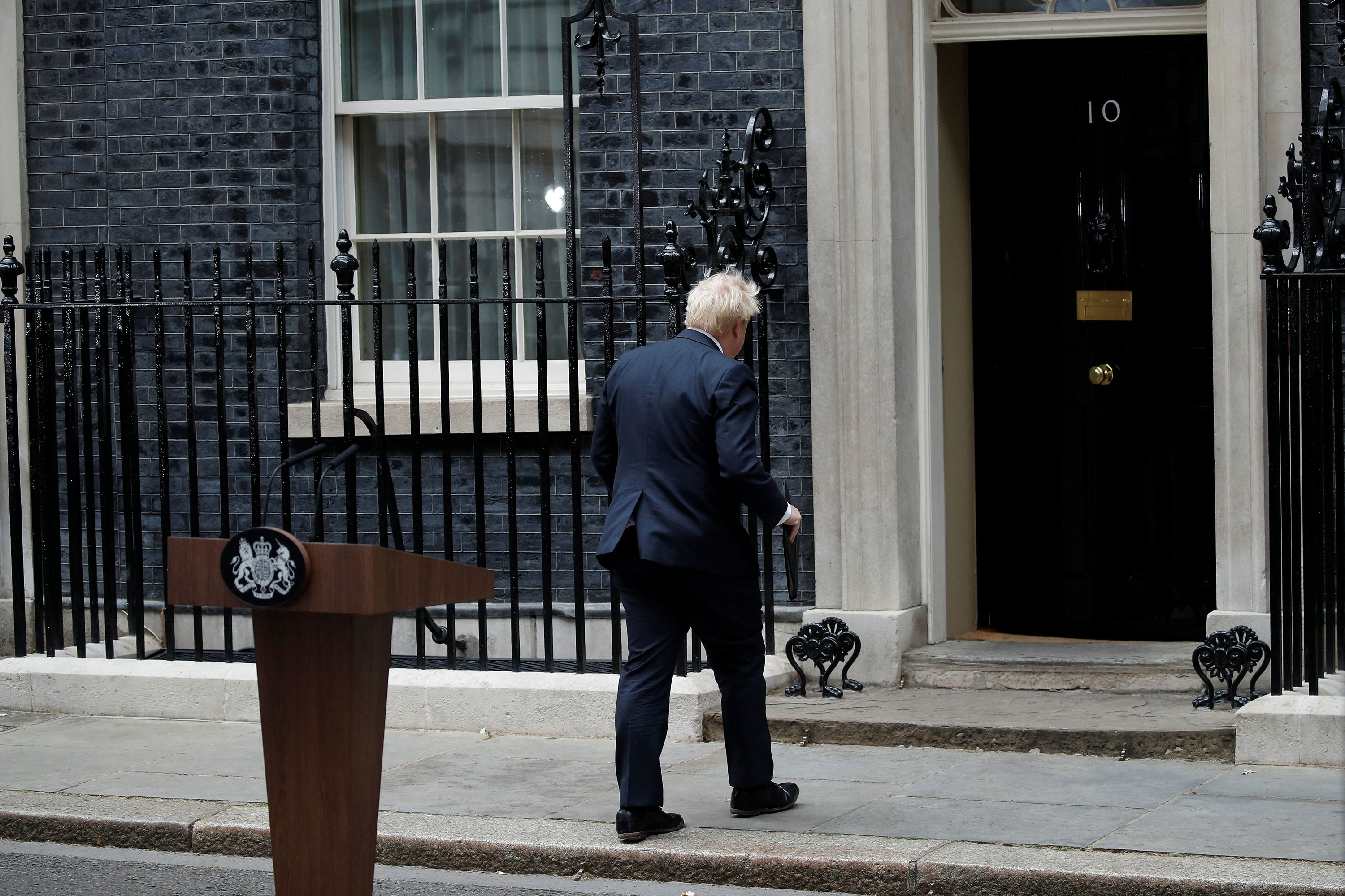 UK Prime Minister Boris Johnson leaves the podium after announcing his resignation on Thursday.