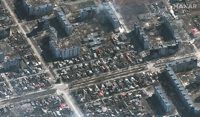 Russian military vehicles and tanks seen on the streets of the "left bank" neighborhood in Mariupol.