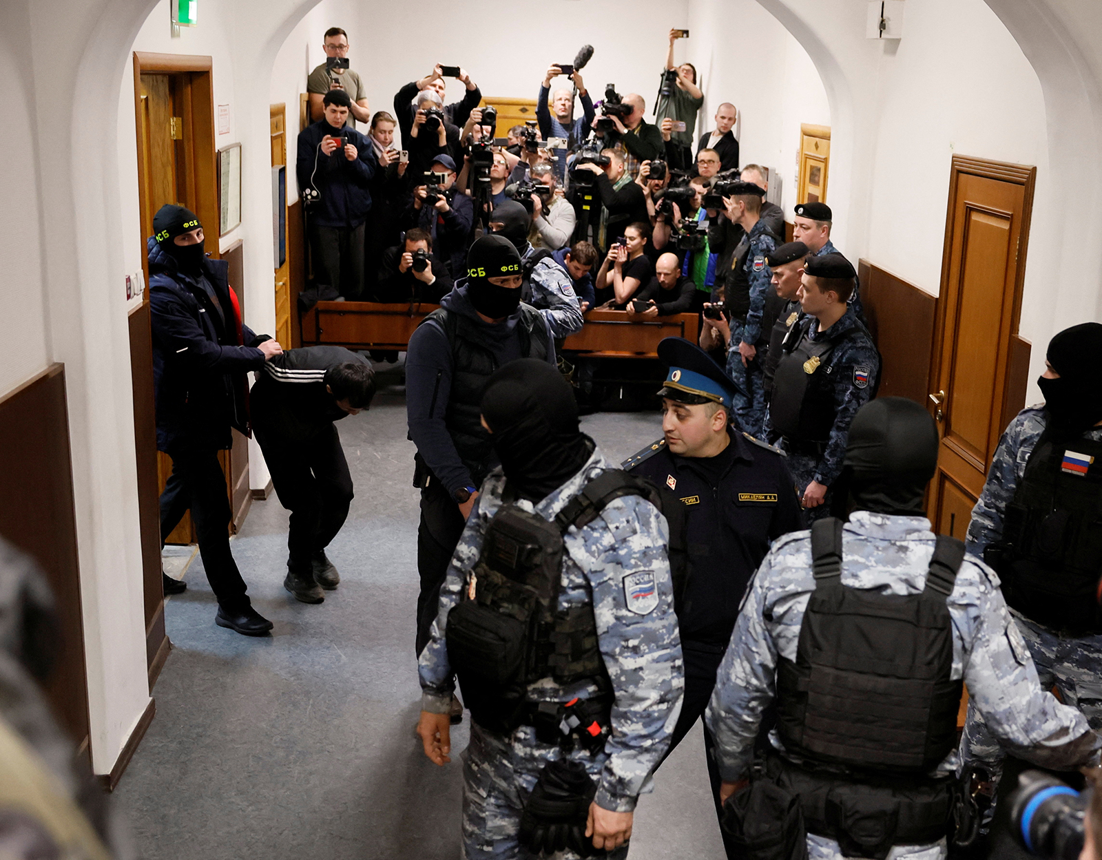 A suspect is escorted before a court hearing at the Basmanny district court in Moscow, Russia March 24.