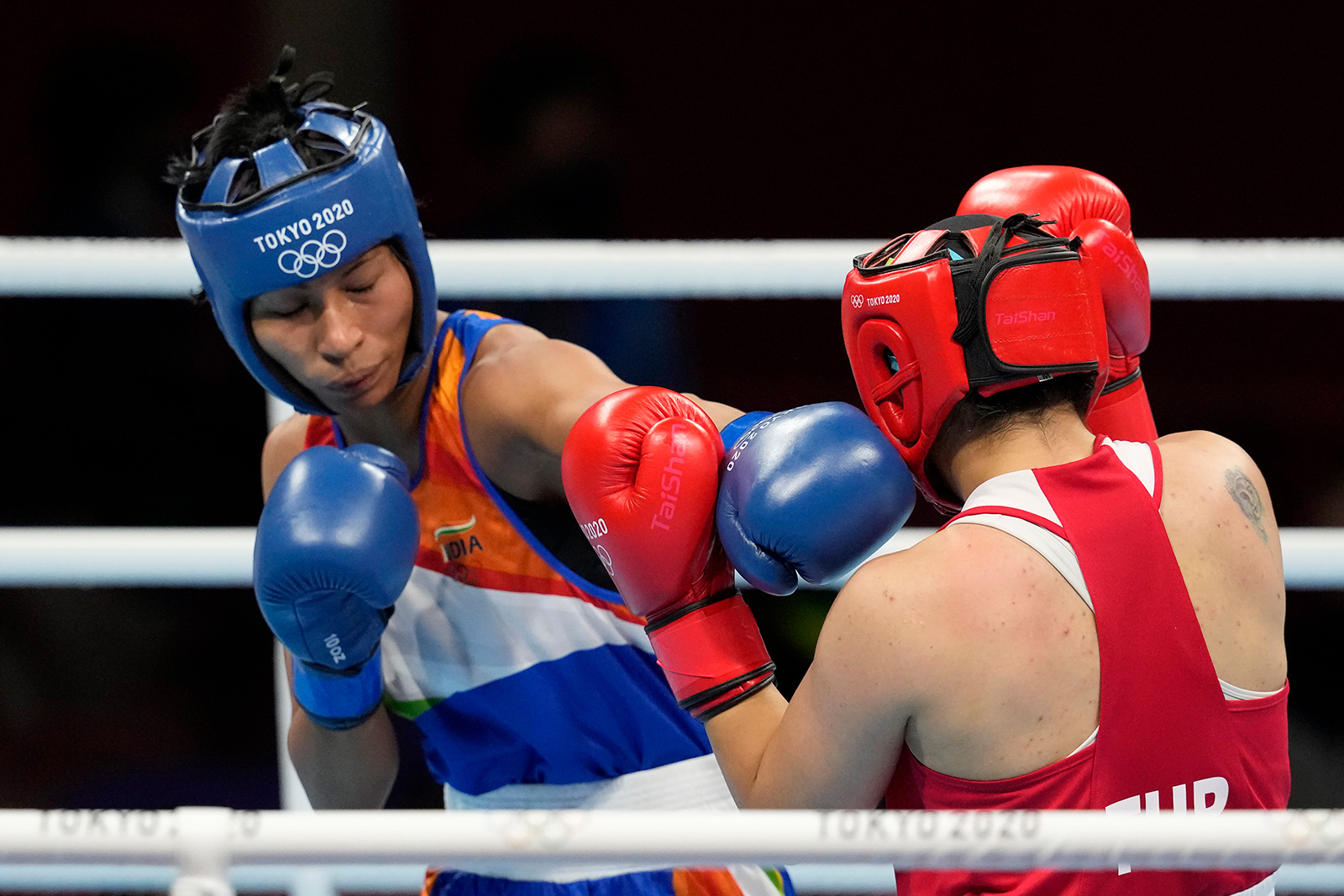 India's Lovlina Borgohain and Turkey's Busenaz Surmeneli exchange punches during their semifinal boxing match on Wednesday.