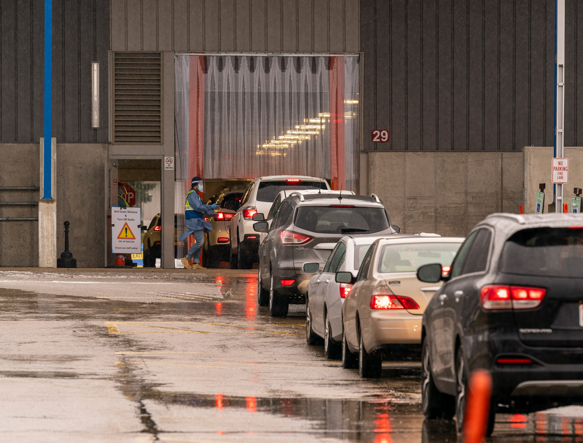 People queue up in their cars for a COVID-19 test at the Alliant Energy Center on November 24 in Madison, Wisconsin. 