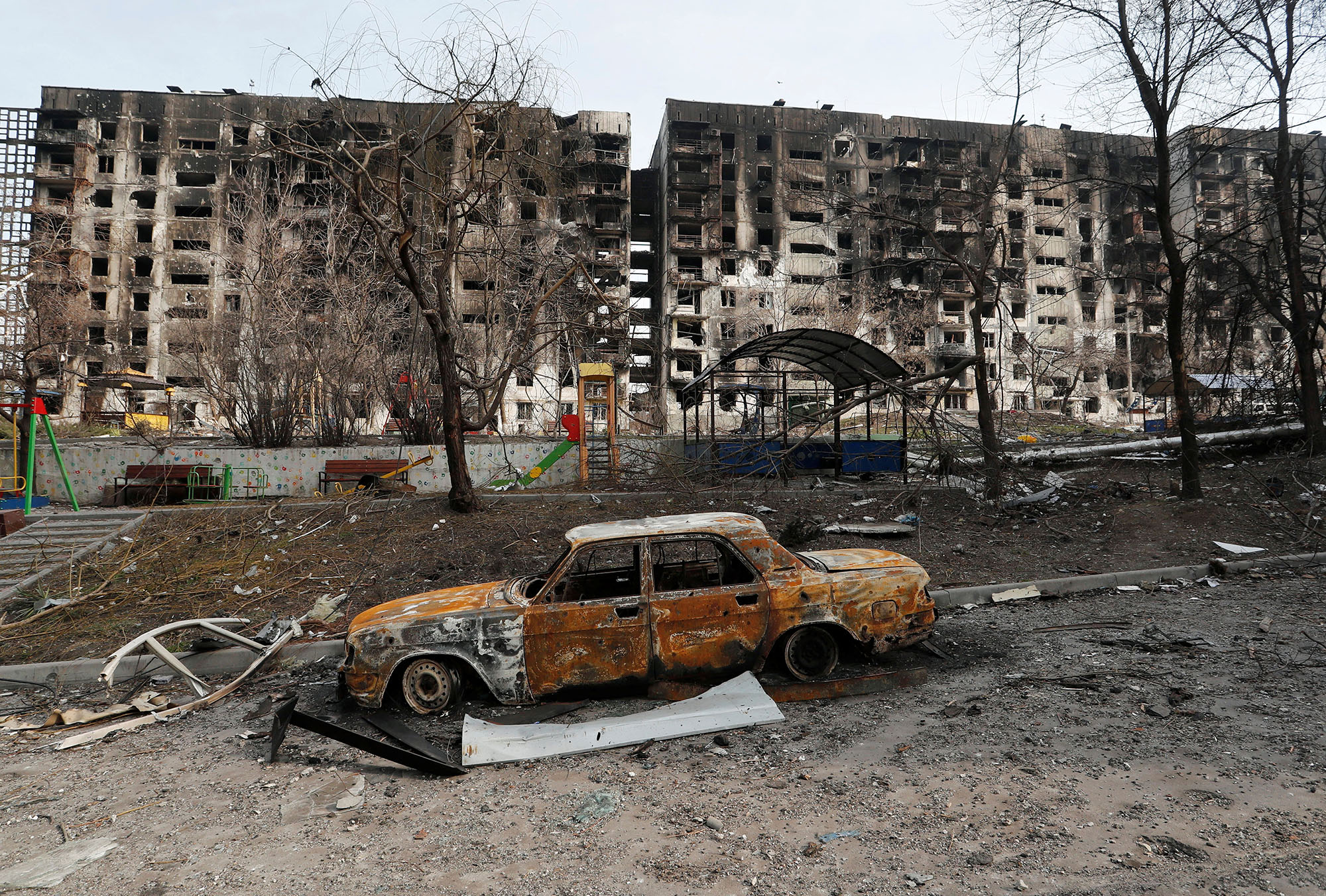 A charred car is seen in front of a destroyed apartment building in the besieged southern port city of Mariupol, Ukraine, on March 30.